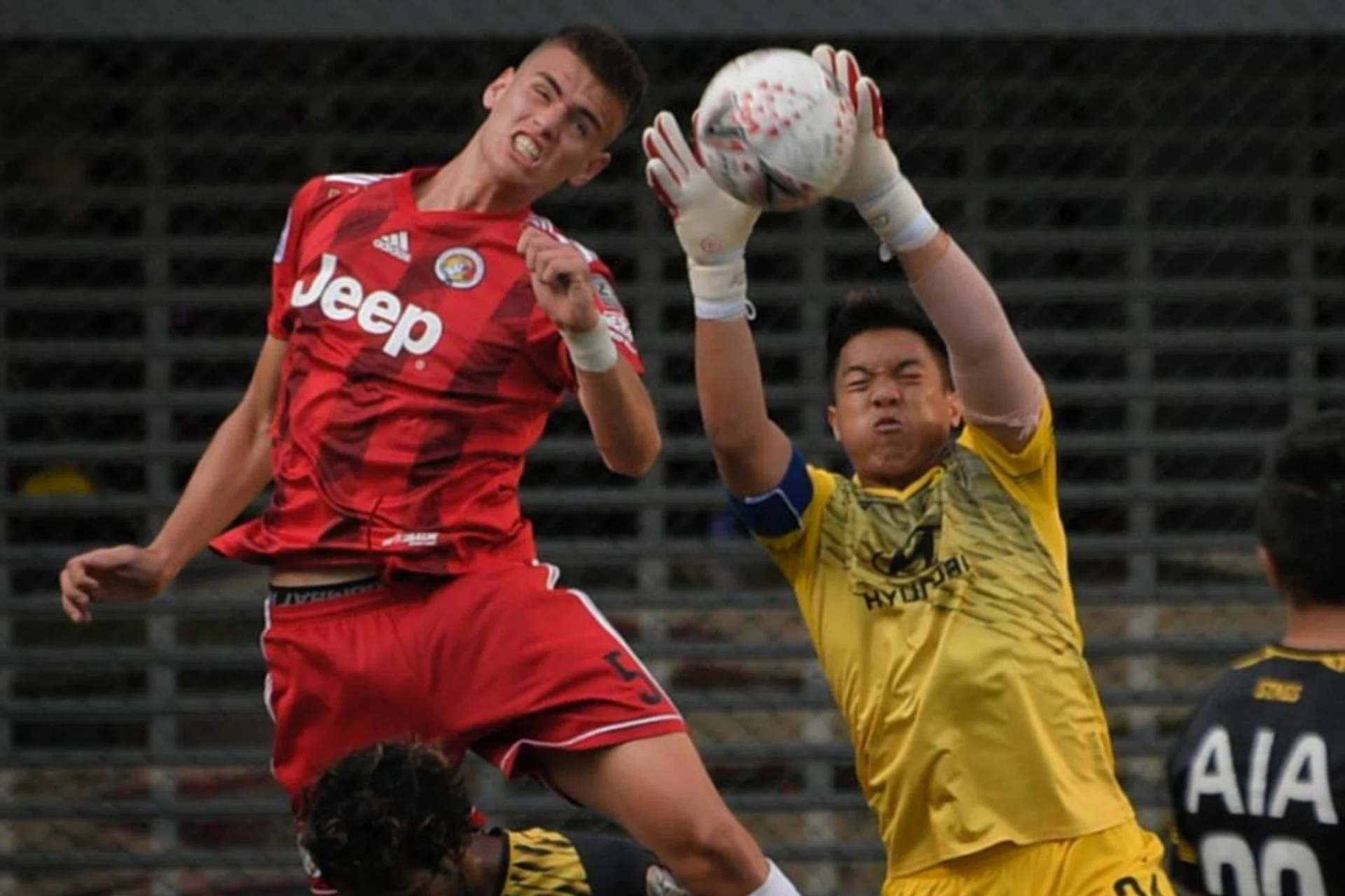 Tampines Rovers goalkeeper Syazwan Buhari (right) claiming the ball as Balestier Khalsa's Ensar Bruncevic challenges.
