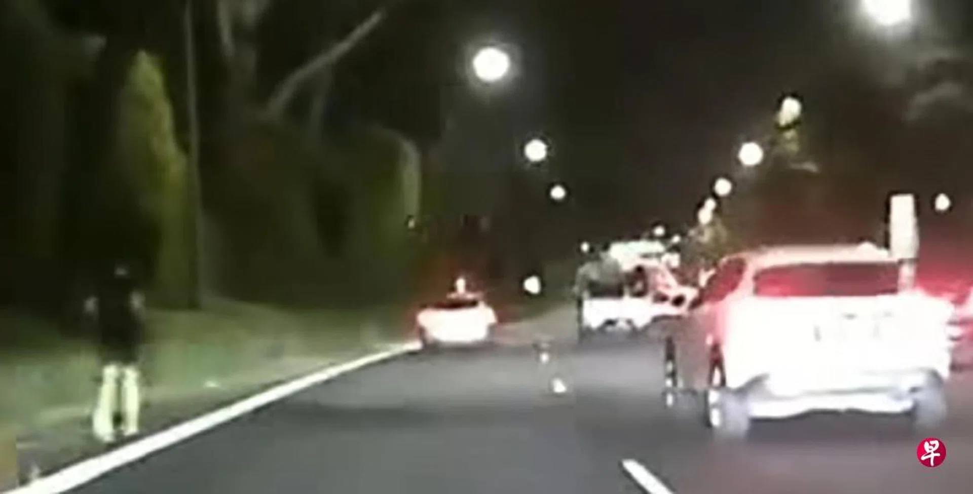 A man dressed in black was seen running along the left shoulder of the expressway as a car travelled in the fourth lane. 