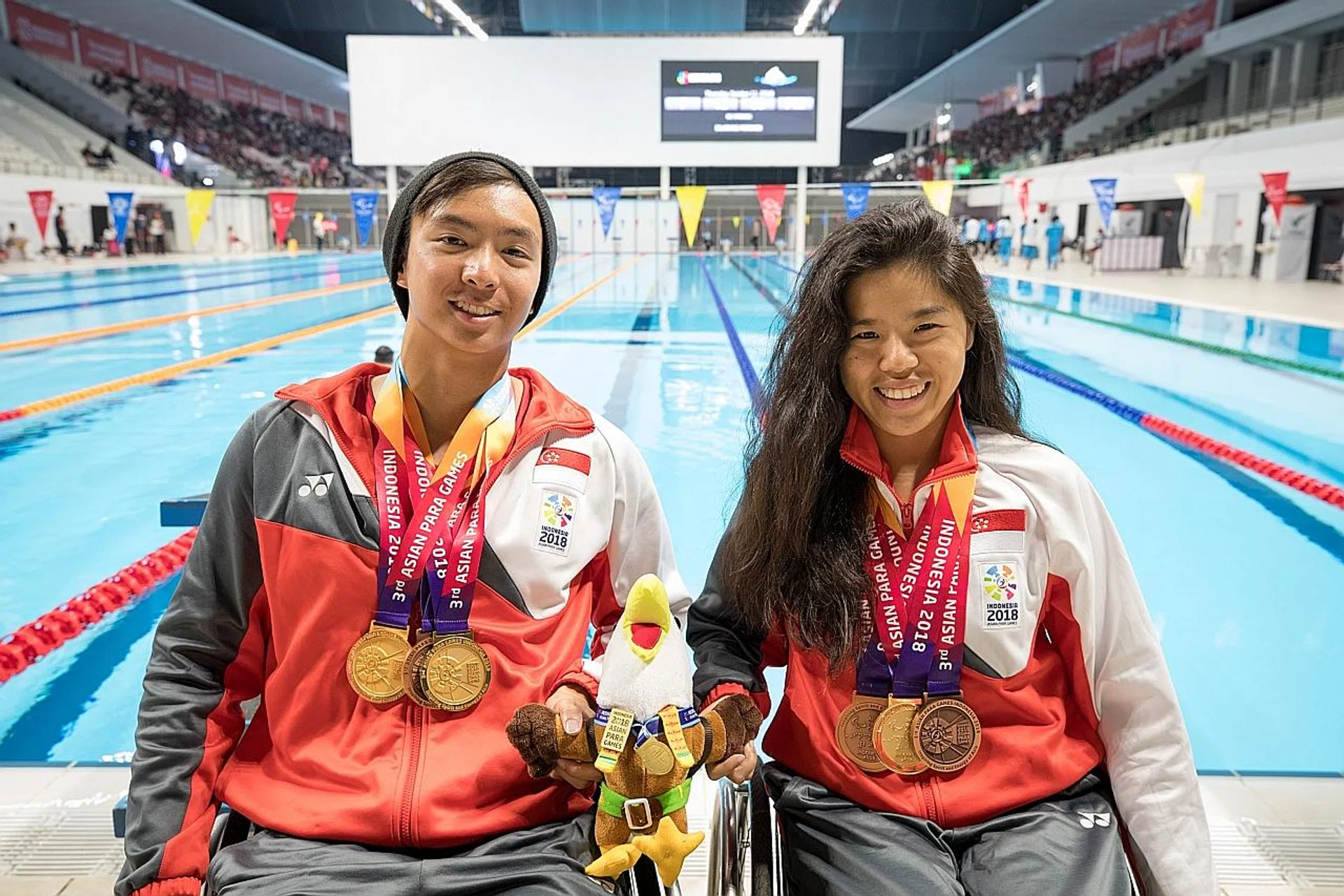 Yip Pin Xiu (right) with fellow para-swimmer Toh Wei Soong, who also won three medals at the Asian Para Games. 