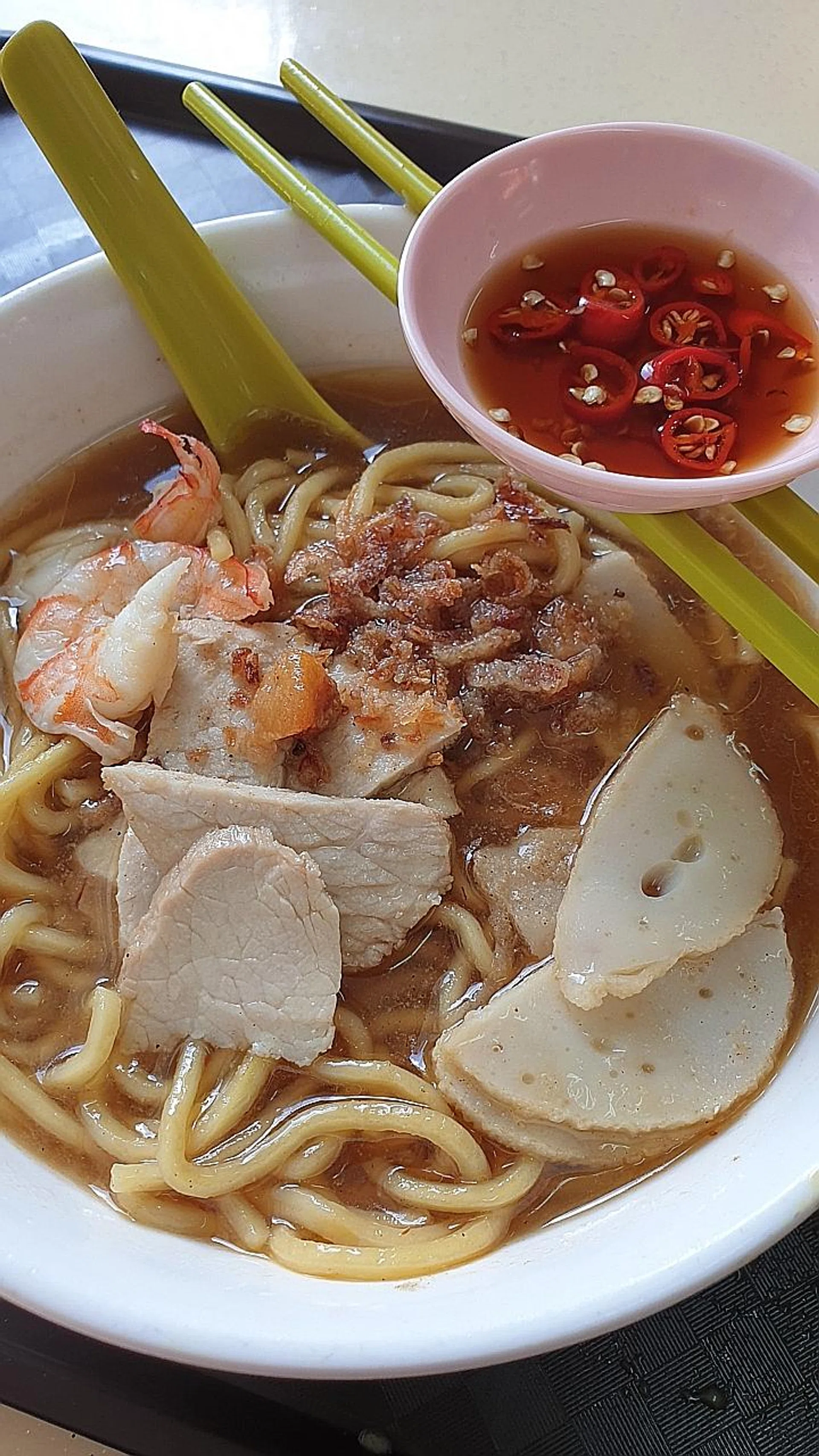 Mr Johnny Lim, his wife, Madam Lee Siew Lian, and his son, Mr Y.Y. Lim, are the team behind the "humble" prawn mee soup (above) and laksa. 
