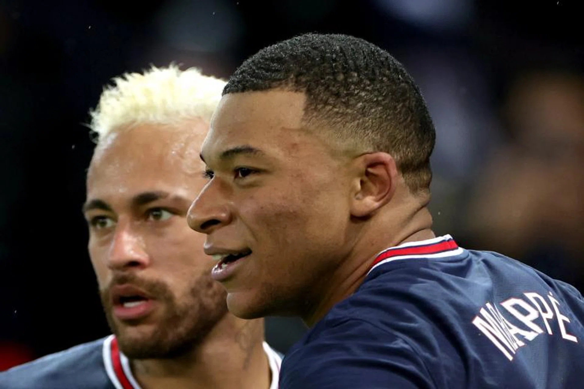 Kylian Mbappe (right) celebrates scoring for PSG with teammate Neymar. 
