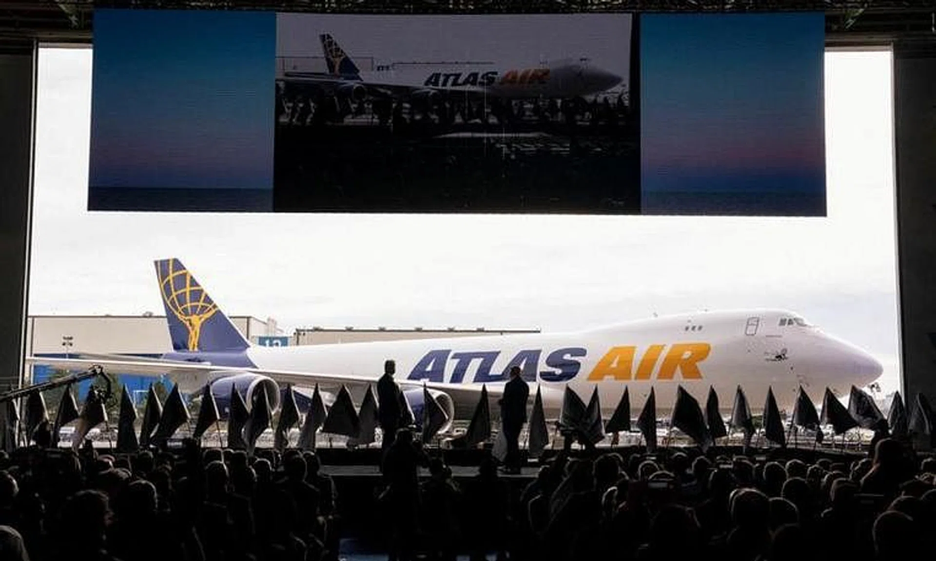 FILE PHOTO: John W. Dietrich, president and CEO of Atlas Air Worldwide, and Dave Calhoun, CEO of Boeing, converse on stage during the delivery of the final 747 jet at their plant in Everett, Washington, U.S. January 31, 2023.  REUTERS/David Ryder/File Photo