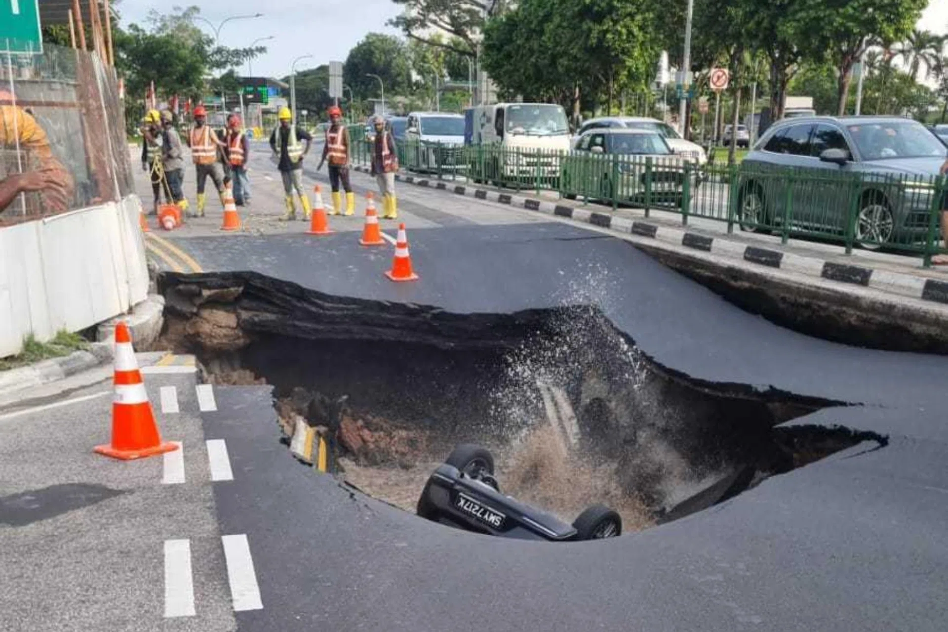 Photos circulating on social media show a sinkhole on one side of the road.