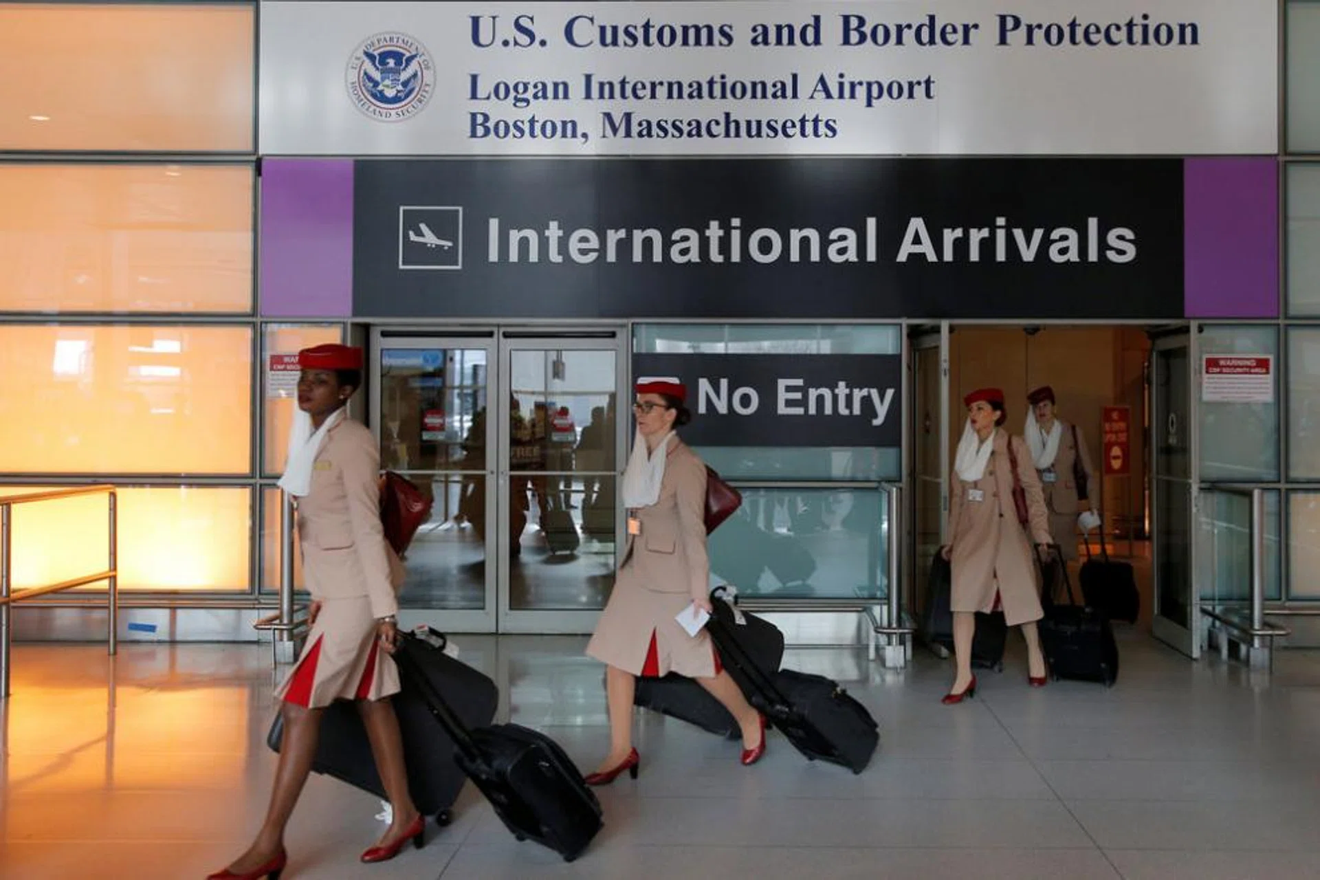 Members of an Emirates flight crew on a flight from Dubai arrives after U.S. President Donald Trump's executive order travel ban at Logan Airport in Boston.