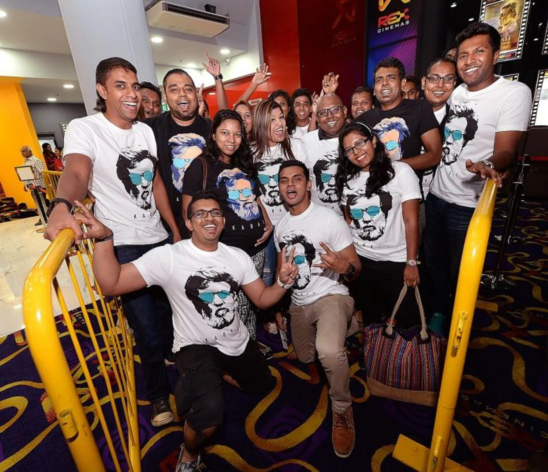 DEVOTED: A group of 30 childhood friends and die-hard fans of Rajinikanth sported matching Kabali T-shirts. With them is Ms Renu Ananthan, 31, (centre, in black) who braved the crowds despite being eight months pregnant.