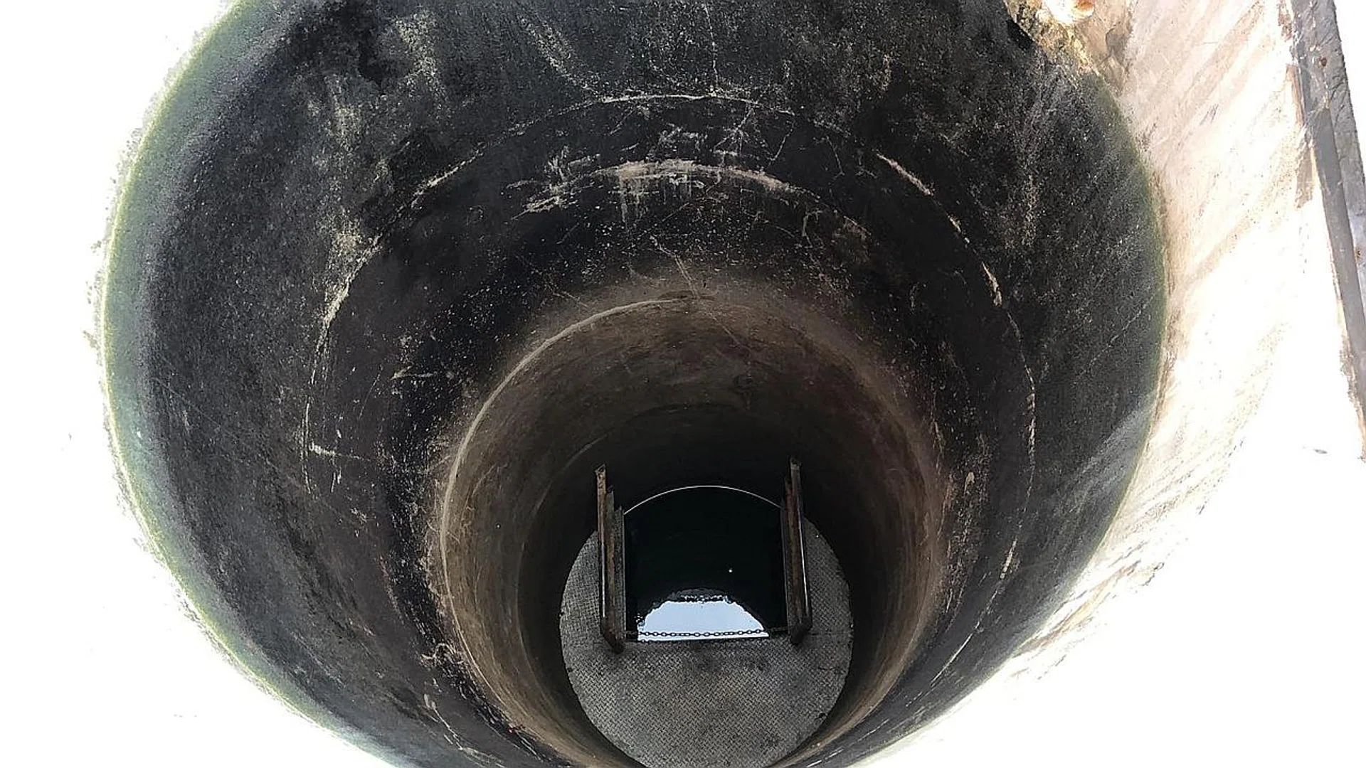 (Above) The 12m-deep well at the Tuas View Fire Station has a diameter of about 1.8m. At the time of the incident, the water level was about 1m below the opening.