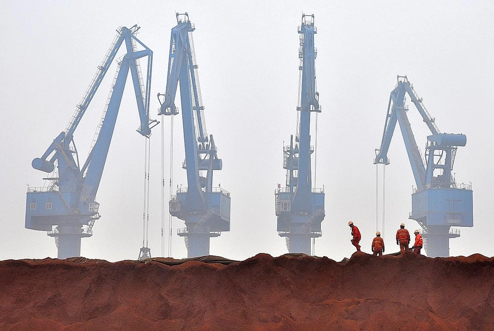 Workers in China preparing to transport iron ore from Australia at a port in Tianjin municipality. 