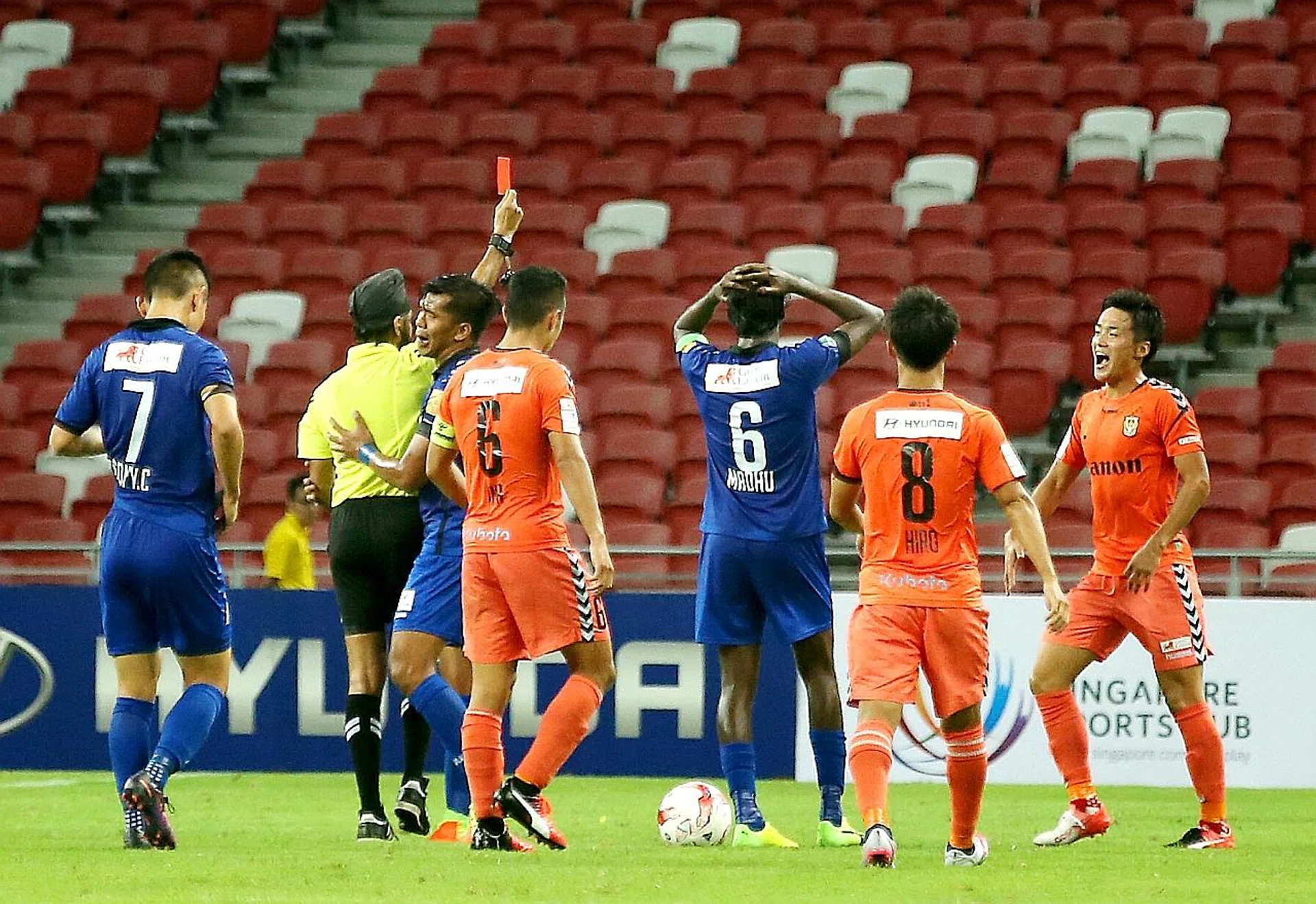 Referee Sukhbir Singh (in yellow) sends off Tampines Rovers captain Madhu Mohana (No. 6) in the Stags' 2-1 loss to Albirex Niigata in the Great Eastern Community Shield tie last night. 