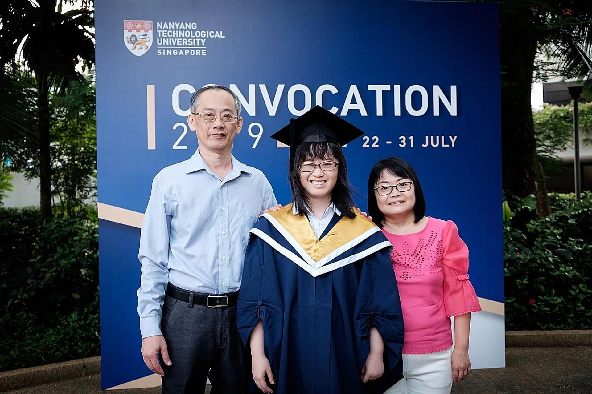 NTU graduates Miss Felicia Lim (above, with her parents) and Mr Mark Yeap.
