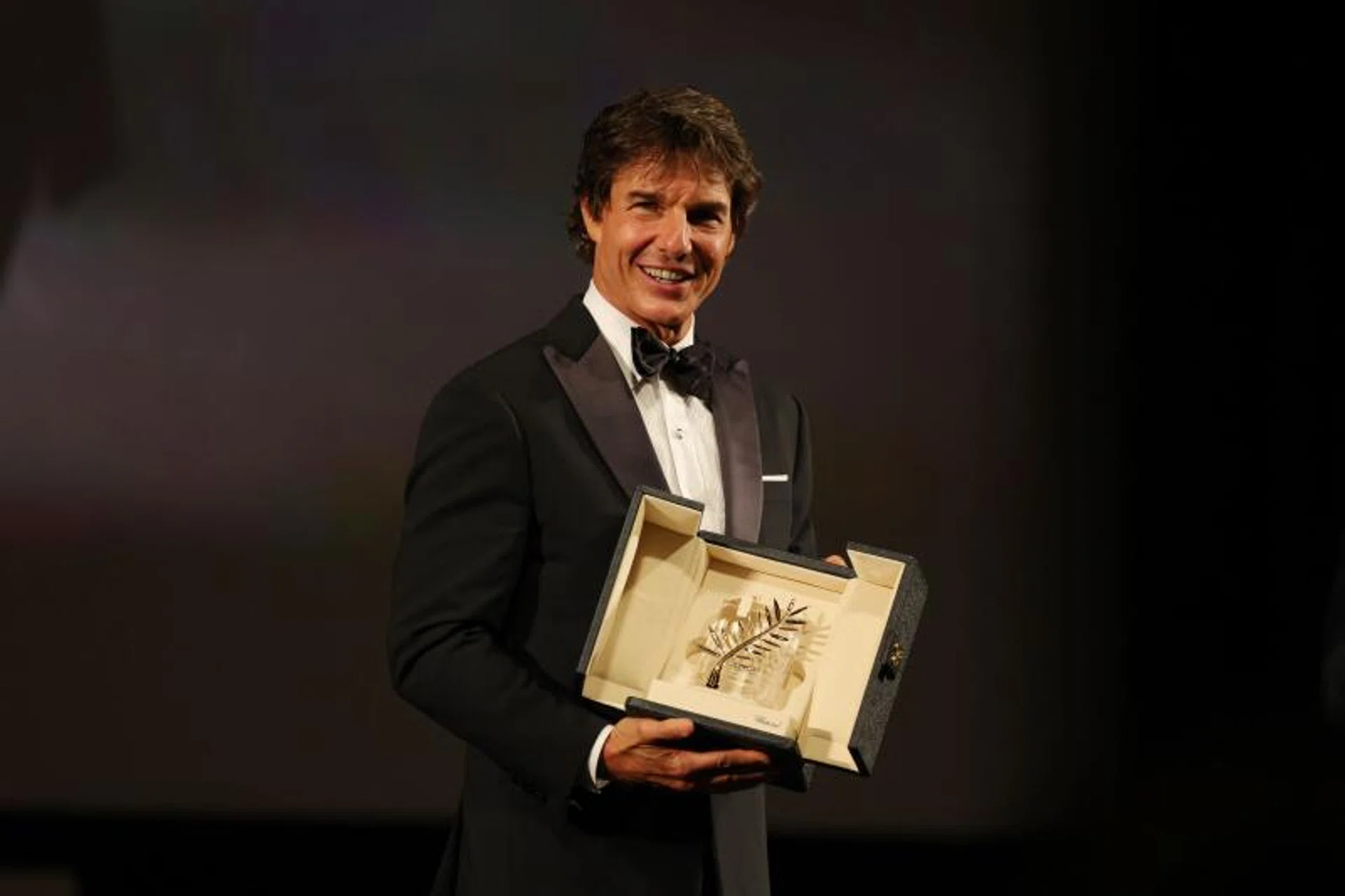 Tom Cruise receives a Palme d'Or d'honneur (honour Palme d'Or) ahead of the screening of Top Gun : Maverick during the 75th edition of the Cannes Film Festival on May 18, 2022.