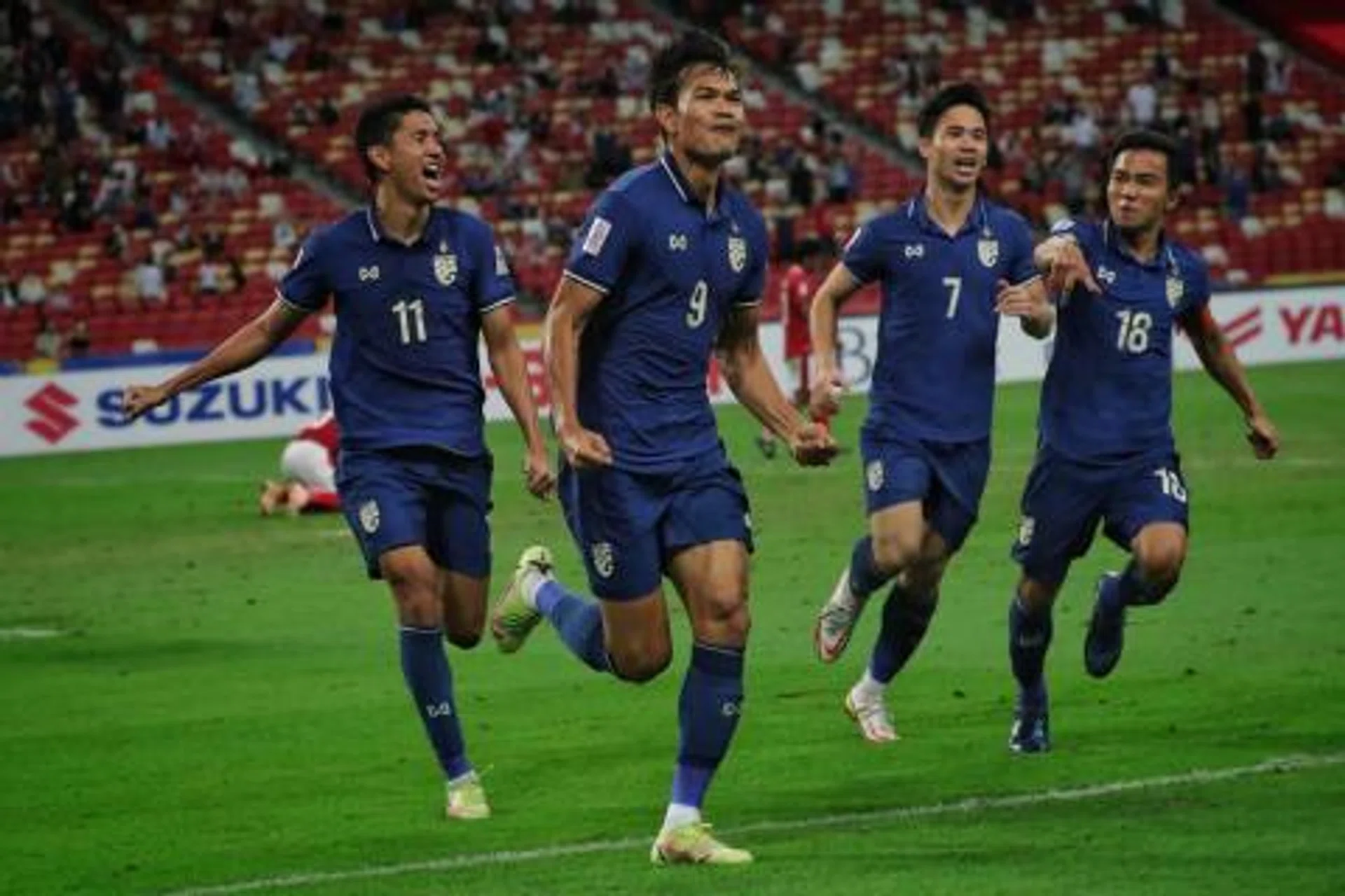 Adisak Kraisorn (second from left) celebrates after scoring the equaliser against Indonesia on Jan 1, 2022.