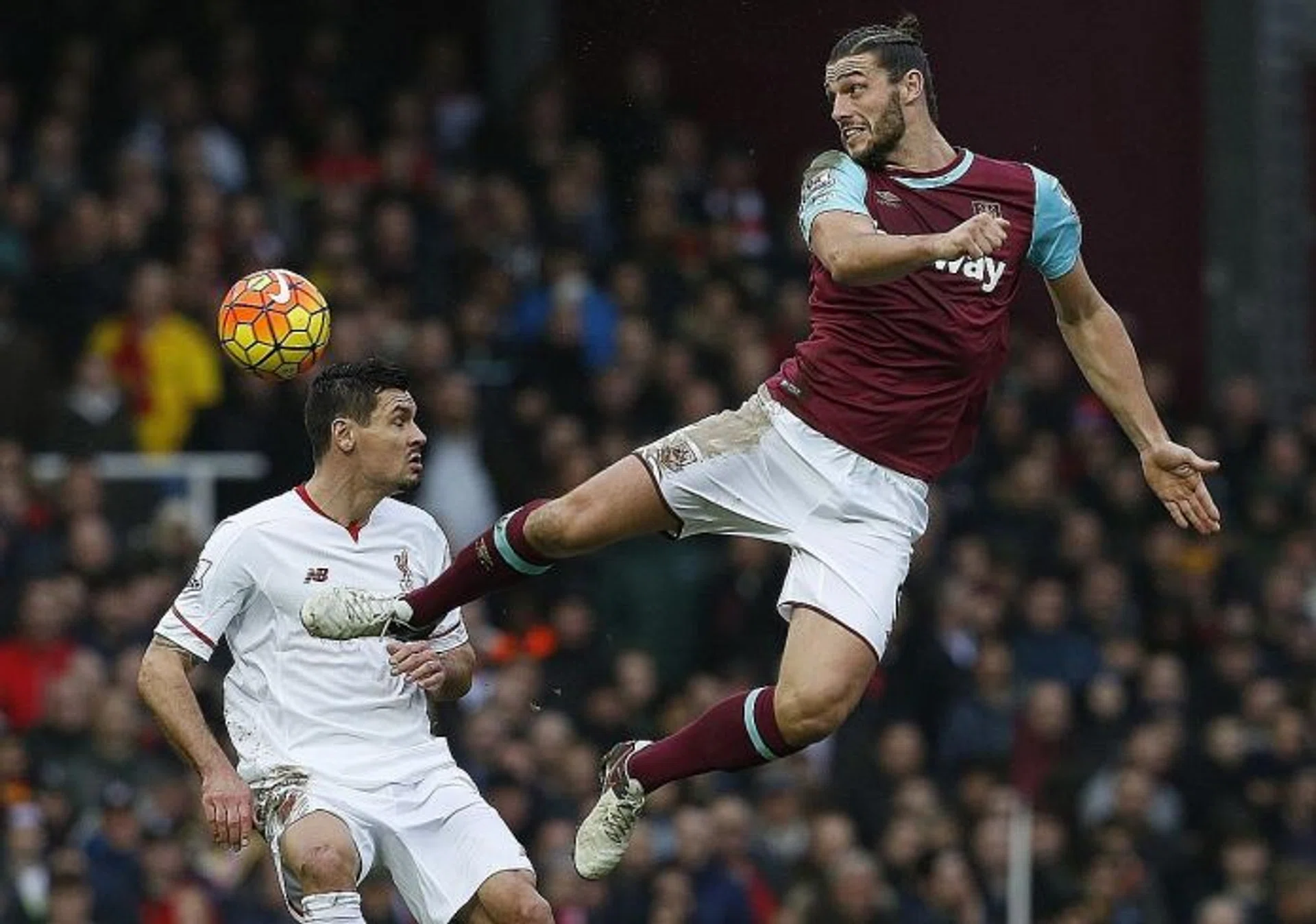 HAMMER TIME: West Ham's Andy Carroll (above) getting one over Liverpool defender Dejan Lovren in the Hammers' 2-0 win  on Saturday.