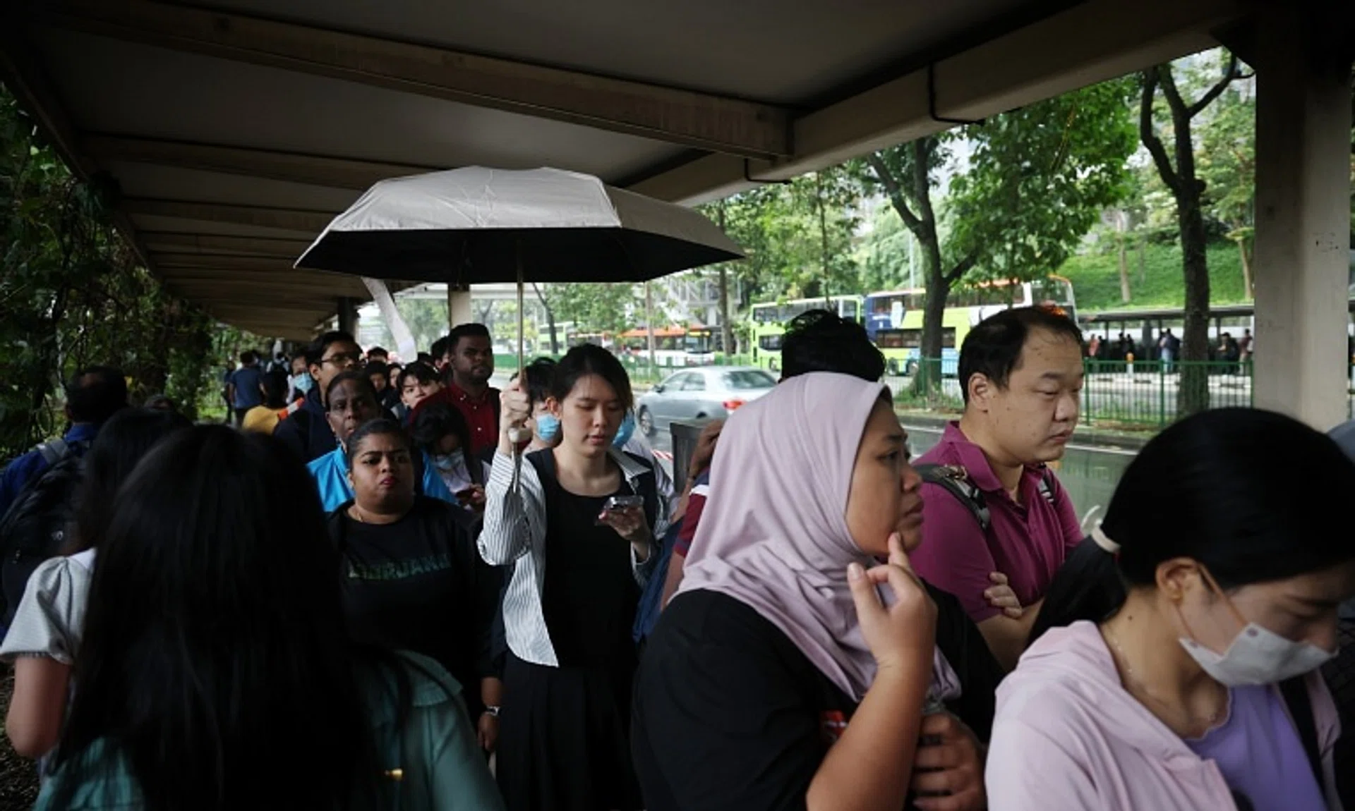 Commuters queueing for the bridging bus service towards Buona Vista from Jurong East on Sept 26.