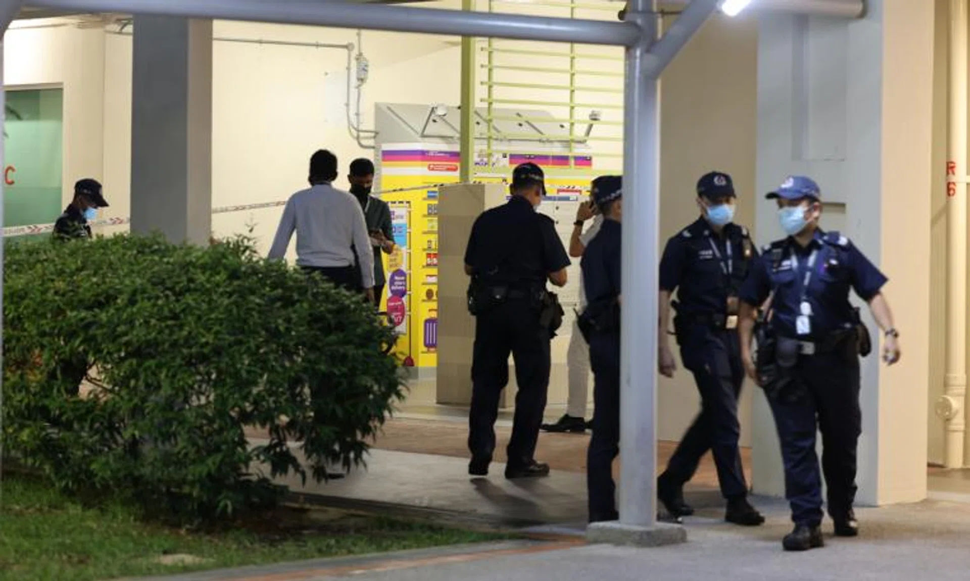 Police officers conducting investigations at Block 59 Strathmore Avenue on March 13, 2022.