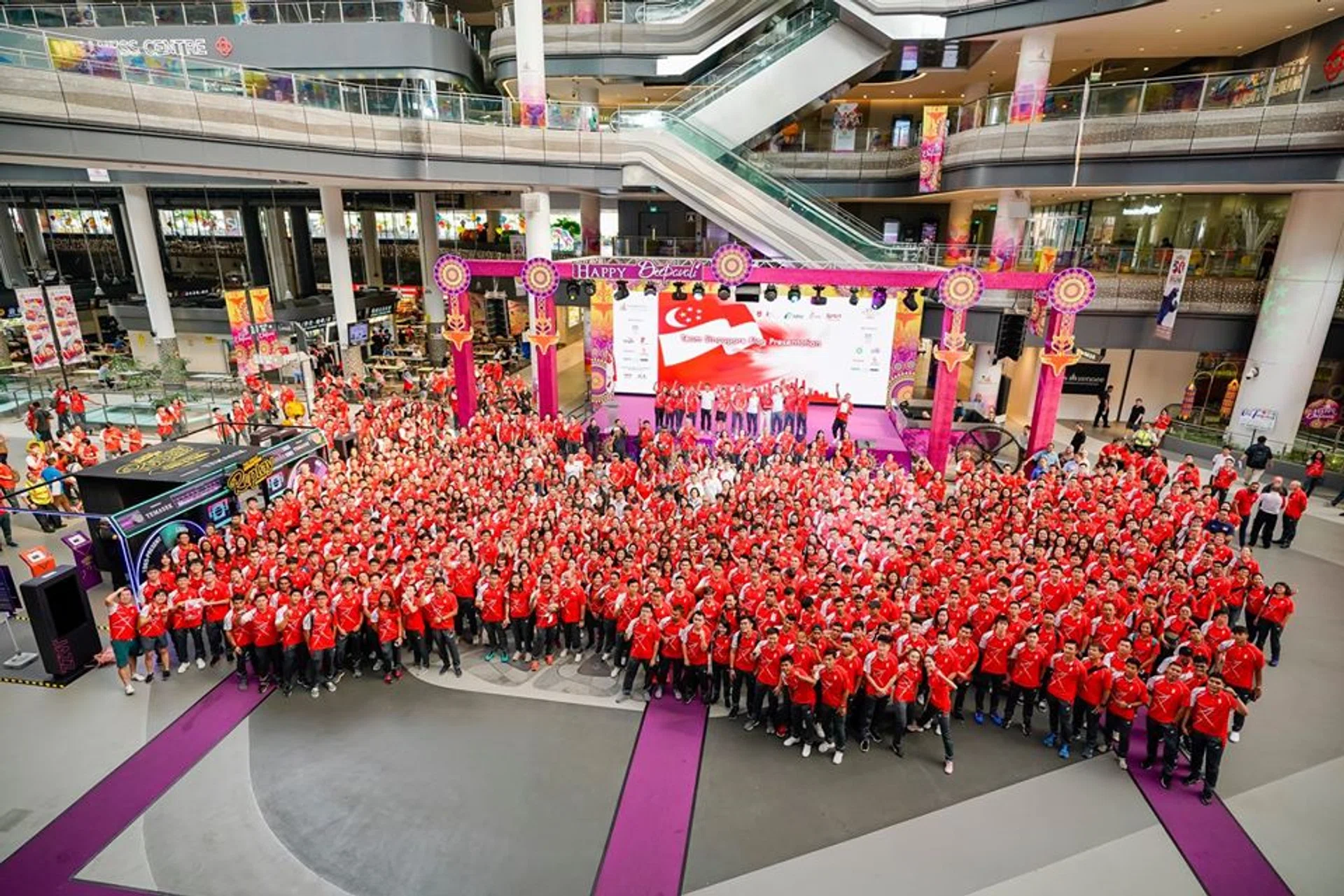 Singapore athletes heading to the SEA Games, Asean Para Games and Winter Youth Olympics taking a group photo at the official flag presentation ceremony at Our Tampines Hub on Saturday (Nov 9).