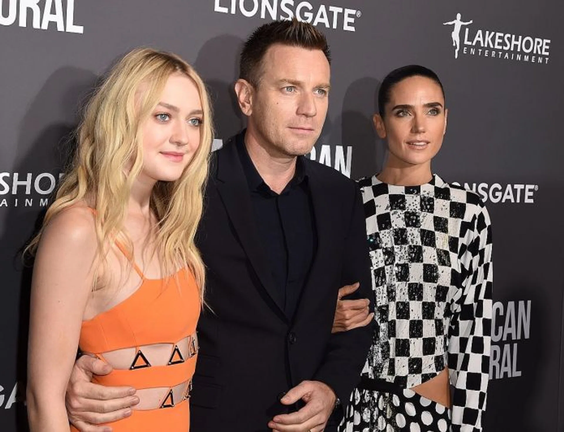 DARK ROLE: US actress Dakota Fanning (above left) plays a radicalised young woman in American Pastoral, which also stars Ewan McGregor (middle) and Jennifer Connelly (in checkered dress).  