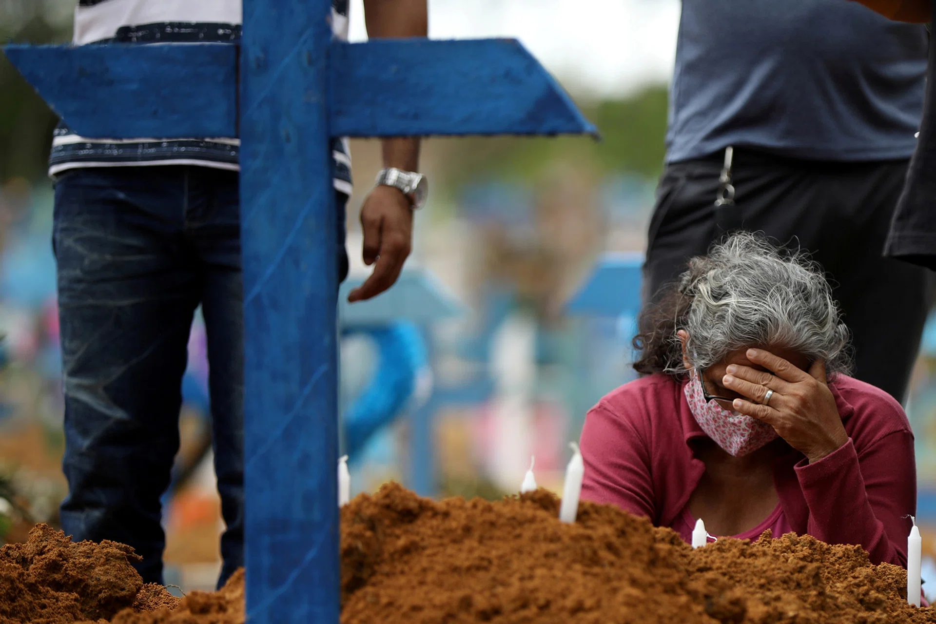 A woman mourning at a mass burial of people who have died from Covid-19 at a cemetery in Manaus, Brazil. 