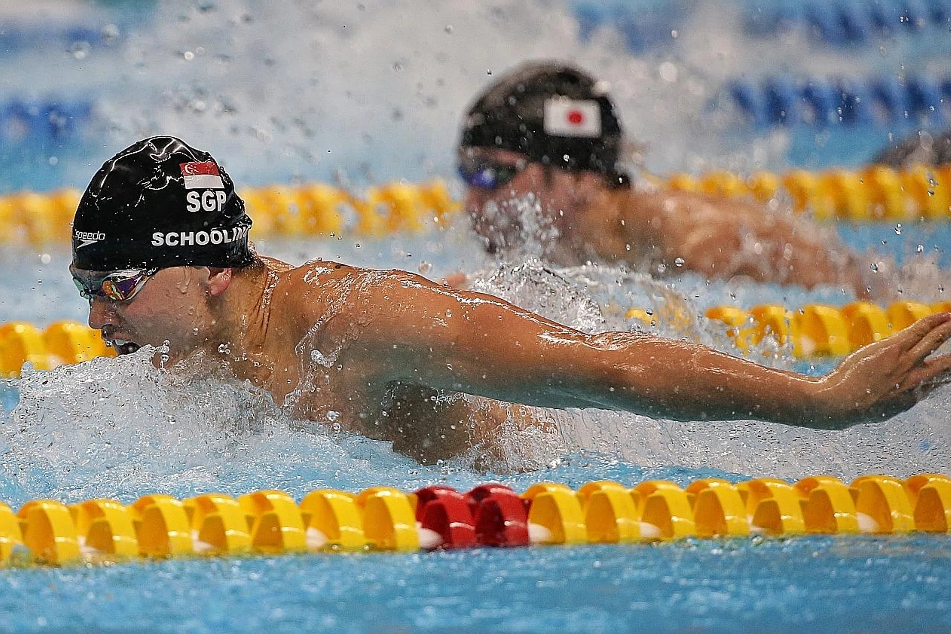 Joseph Schooling (above) winning the 100m butterfly in 51.04sec yesterday, as Japan's Yuki Kobori (background) took the bronze in 51.77.