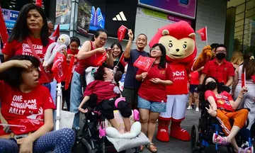 Thousands cheer on Paralympians in celebratory bus parade