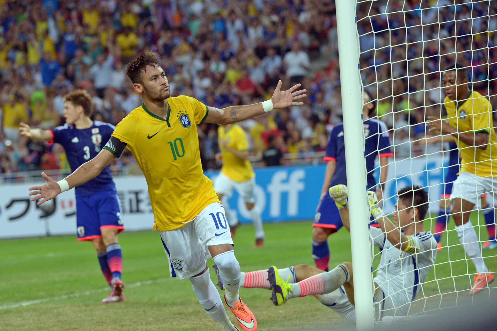 Brazil star Neymar scores one of his four goals at the National Stadium during his side's 4-0 win over Japan in 2014. 
