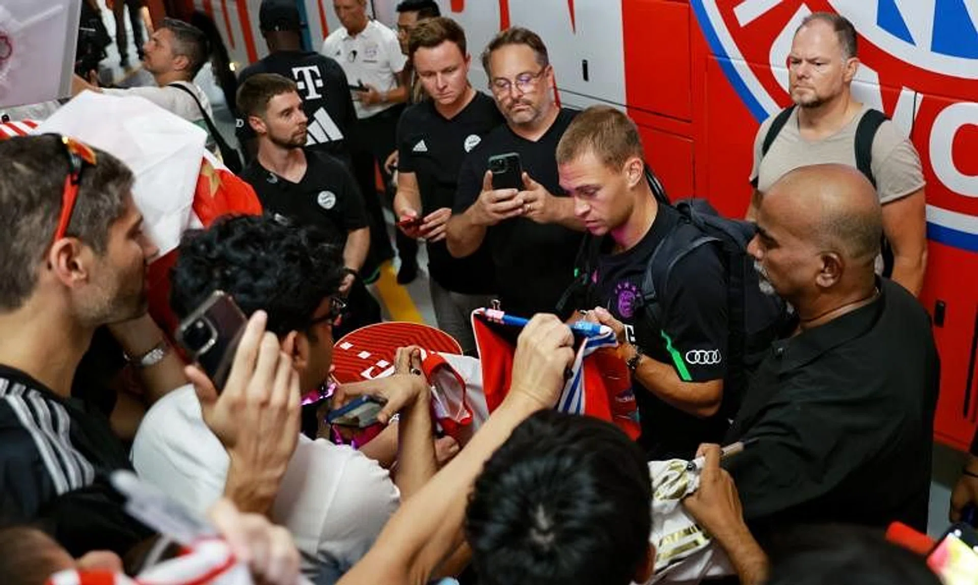 Bayern Munich’s Joshua Kimmich signing autographs for fans at the Andaz Singapore hotel on July 30.