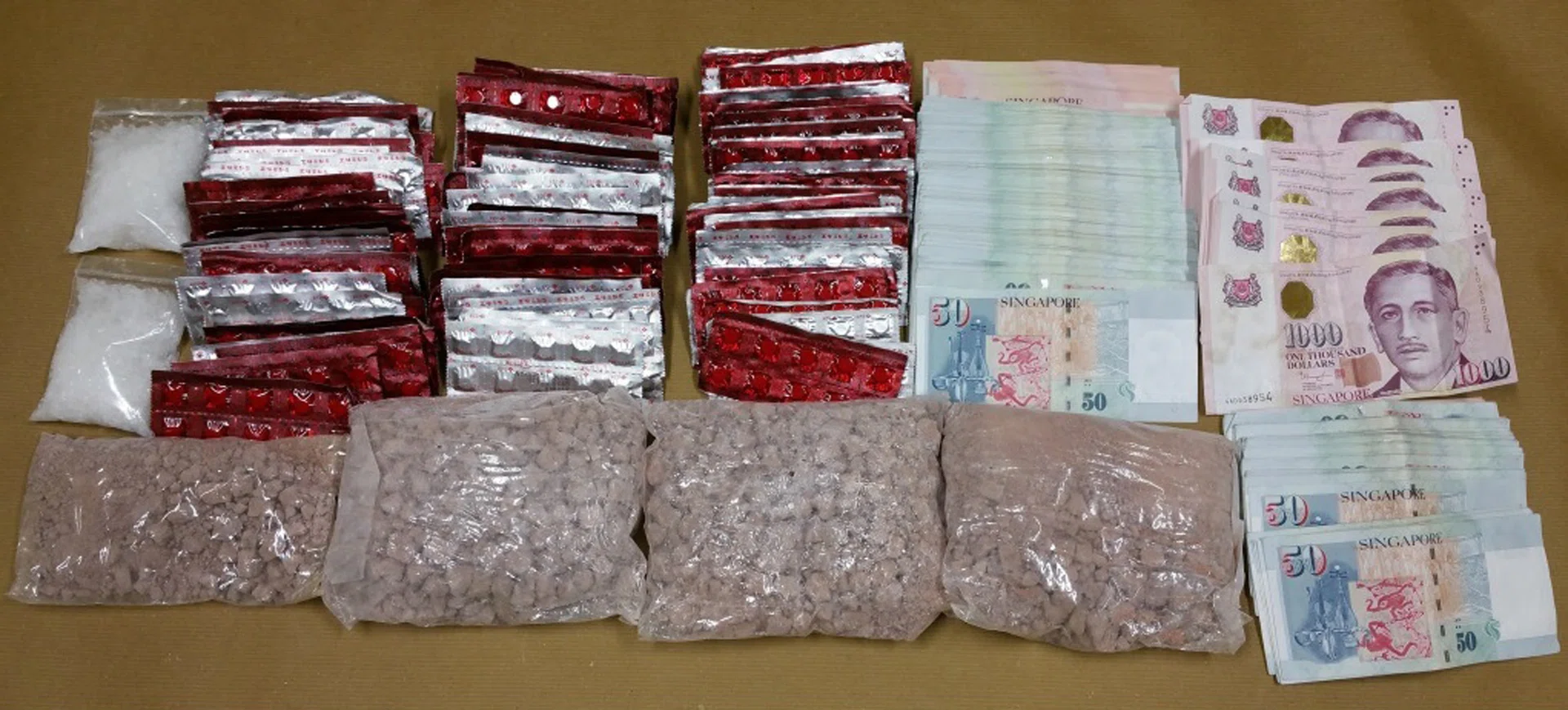 BIG HAUL: CNB officers seized about 1.8kg of heroin, 1,462 Erimin-5 tablets and 454g of Ice in the six-day raid. 