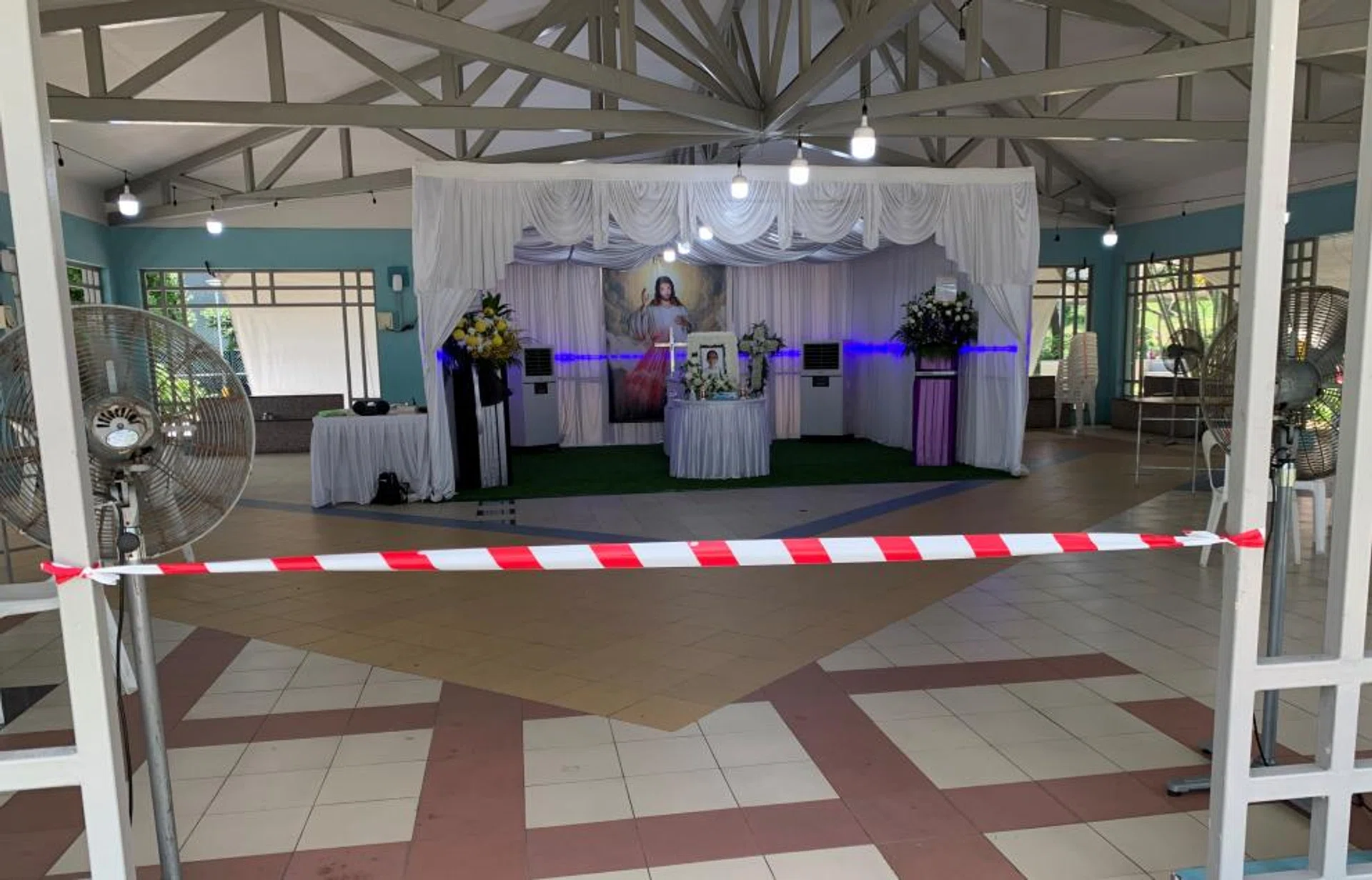 The wake of the writer’s father with tape cordoning off entrances and few tables and chairs provided to discourage mourners from gathering.