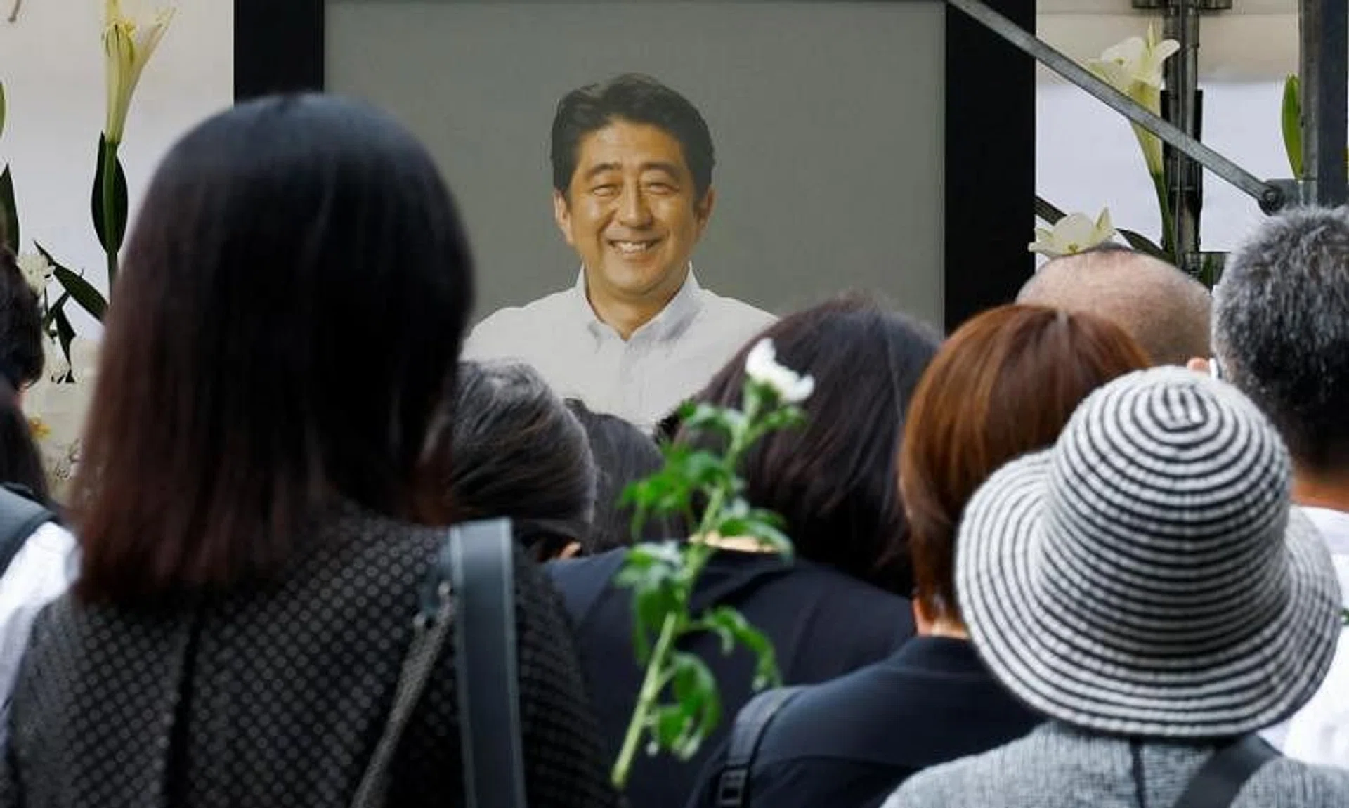 People offer flowers at Tokyo's Zojoji Temple on July 12, the site of late former Japanese PM Shinzo Abe's funeral.