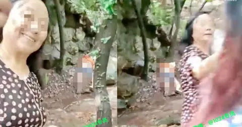 Woman smiles for selfie as tourist lays knocked out behind her