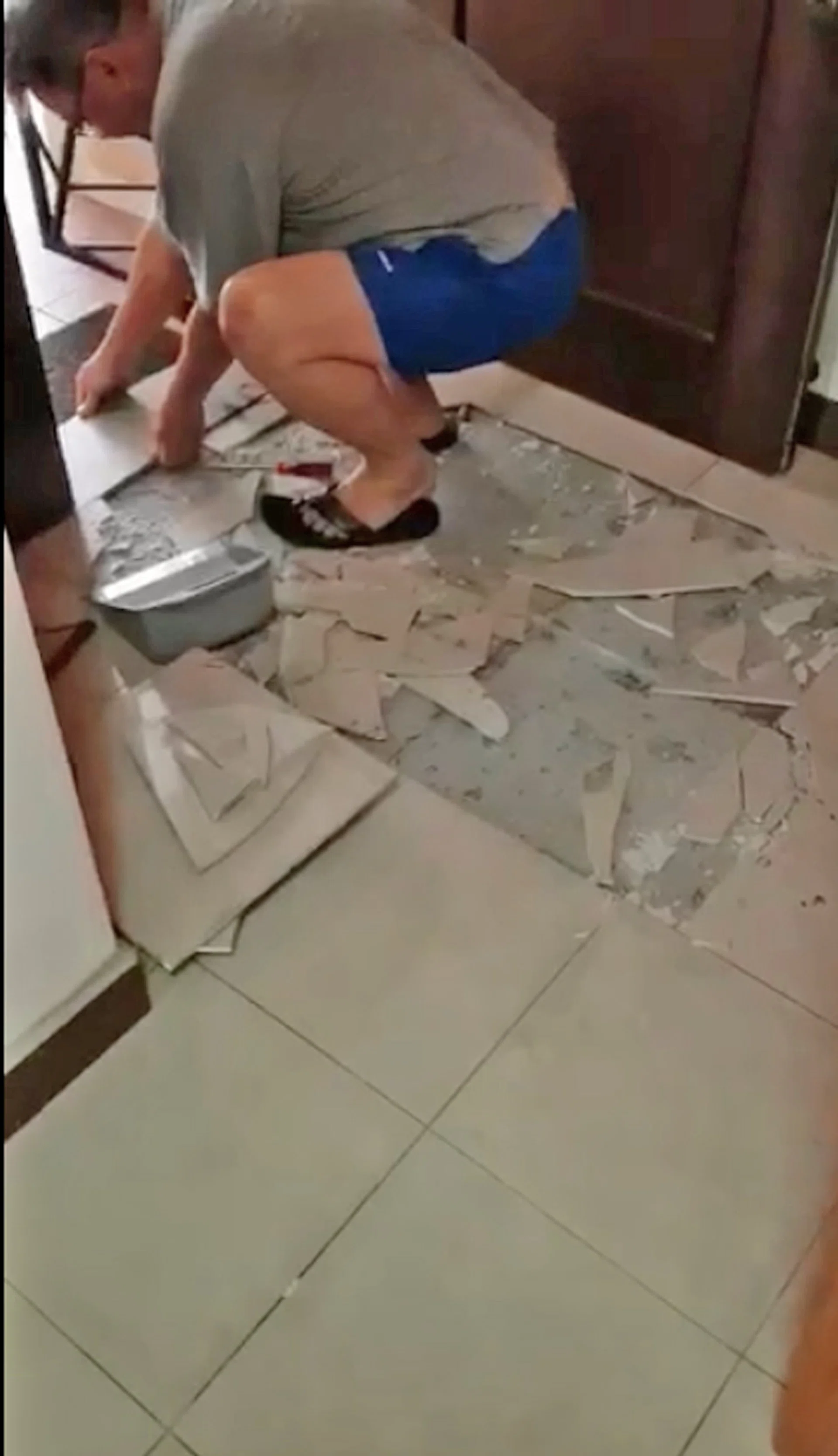 Tiles shattered in the living room of a Fernvale flat. 