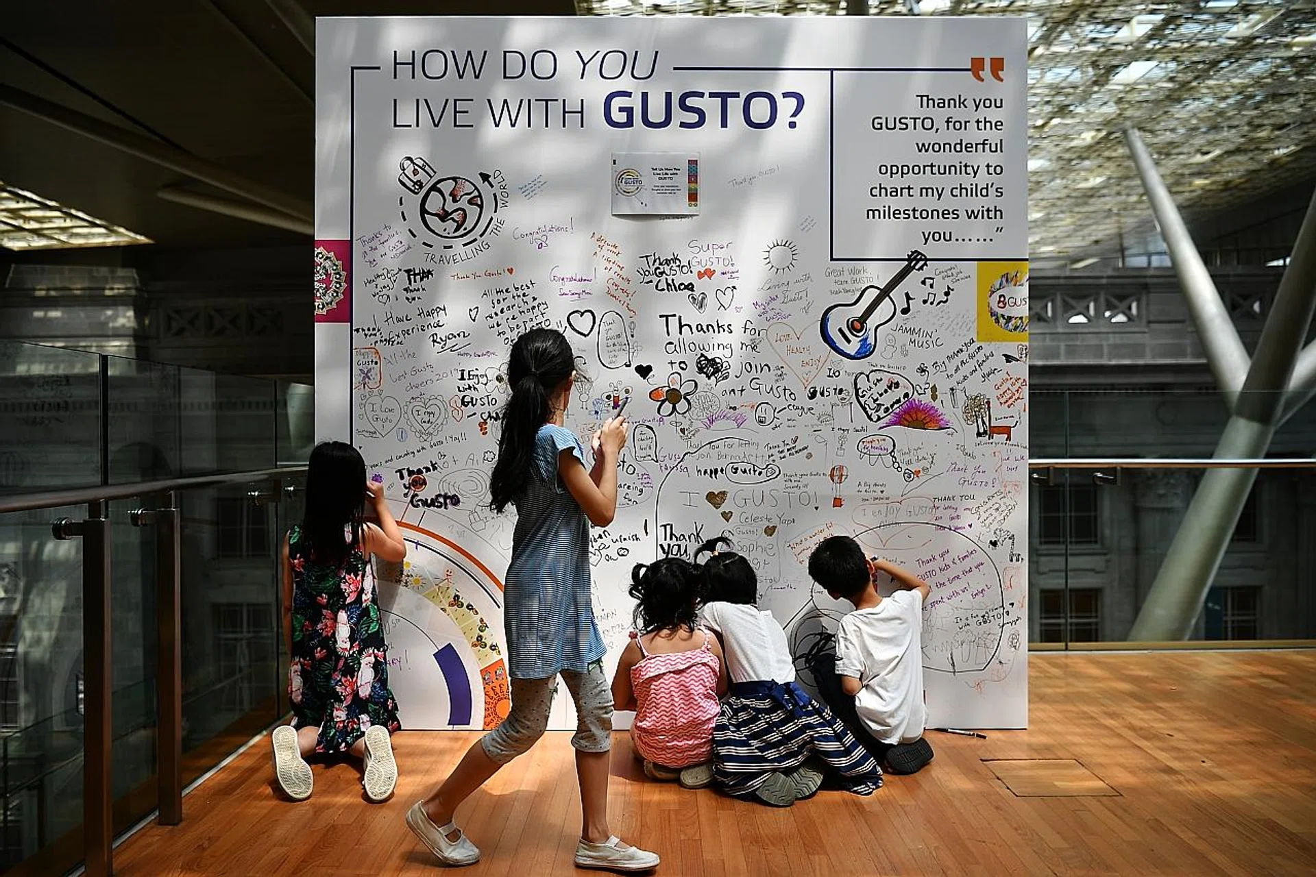 Children leaving their messages on a board during Gusto's 10th anniversary celebration at National Gallery Singapore yesterday. 