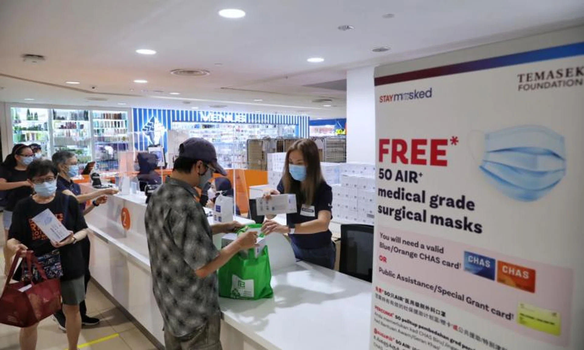 Ascott Residence Trust Management deputy CEO Serena Teo (right) distributing boxes of medical grade surgical masks to members of the public at Junction 8 on Feb 28, 2022.