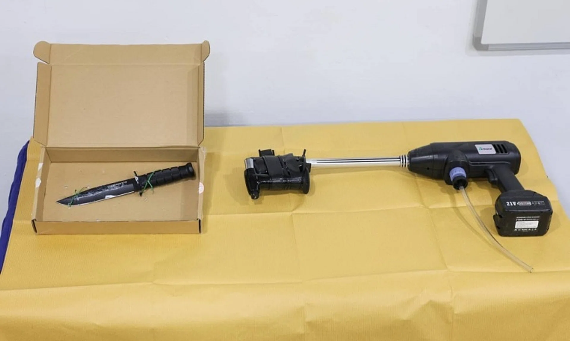 An improvised flamethrower (right) and a knife were seized at the scene of the incident. 