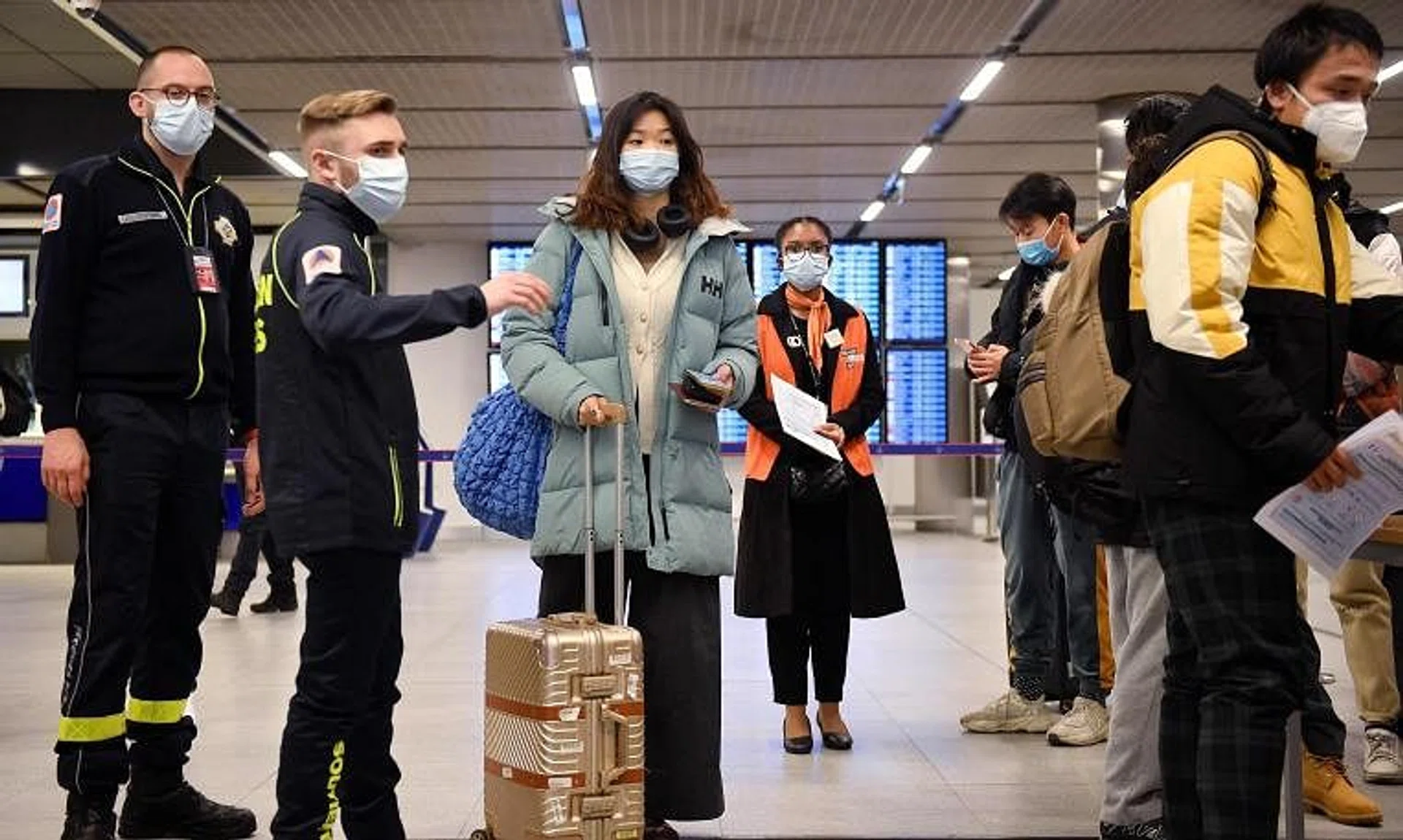 Passengers of a flight from China wait in a line for checking their Covid-19 vaccination documents as after arriving at the Paris-Charles-de-Gaulle airport on Jan 1.
