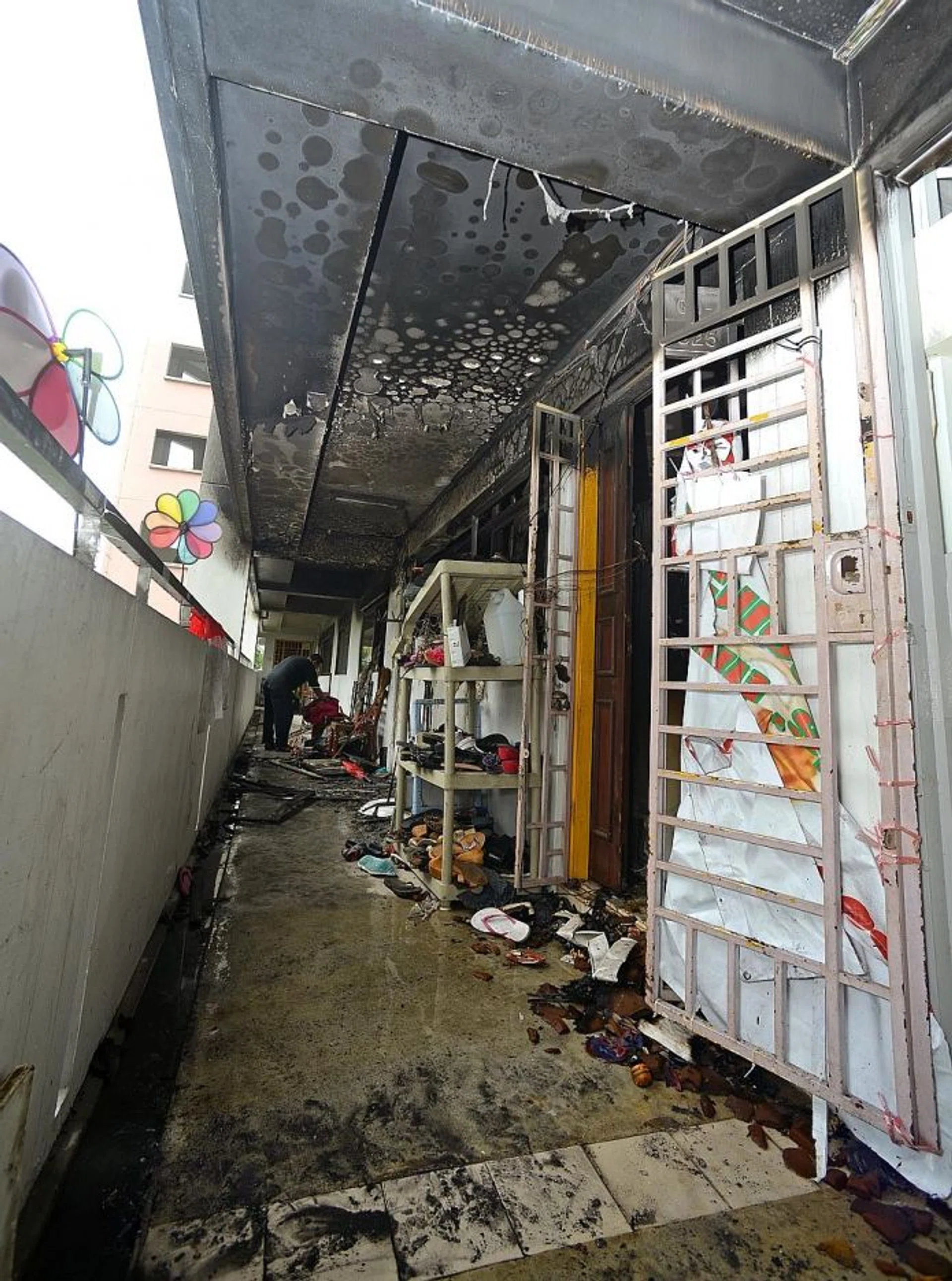 BURNED: The four-room flat was destroyed by a fire, leaving the family living there to salvage whatever they could.
