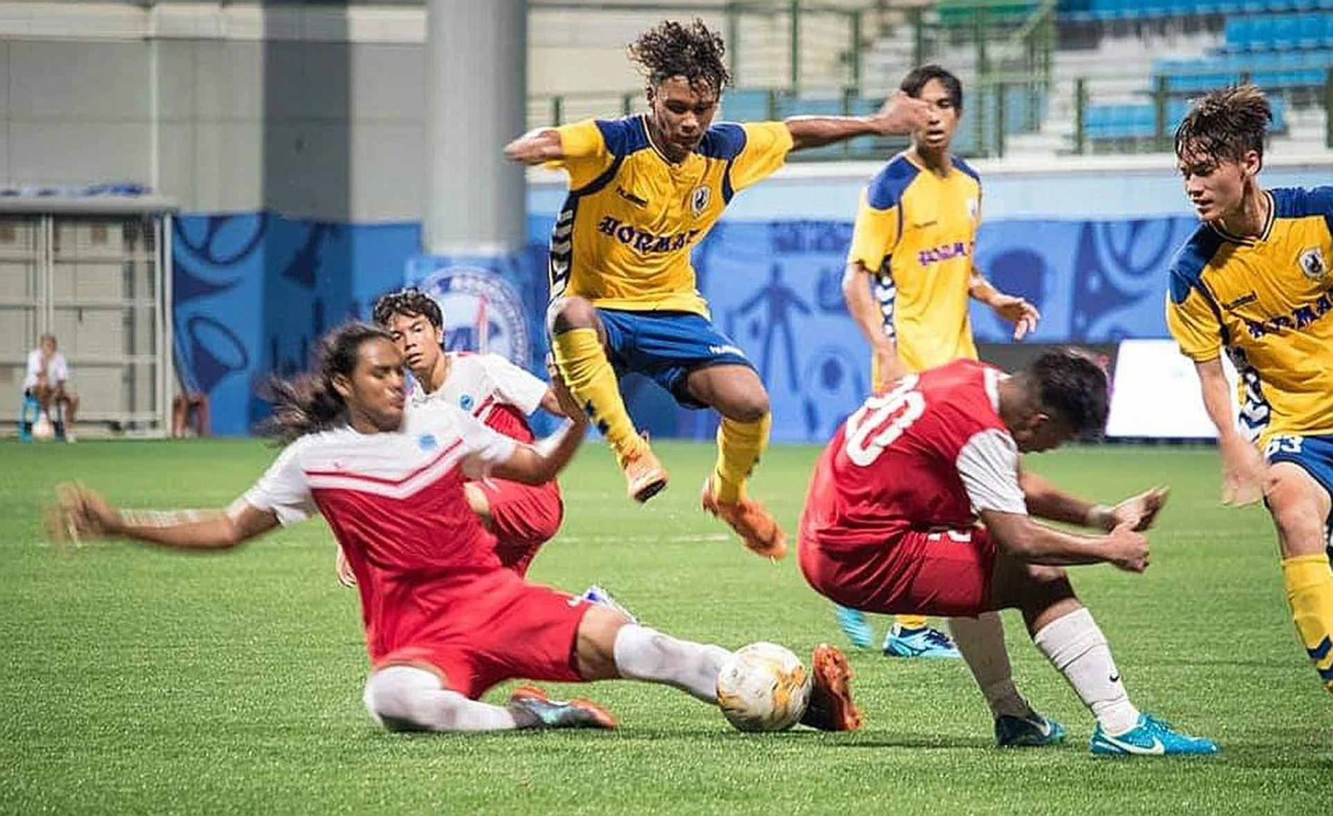 Hari McCoy (jumping) in action for the Stags in the Centre of Excellence U-19 Challenge Cup final in 2018.  