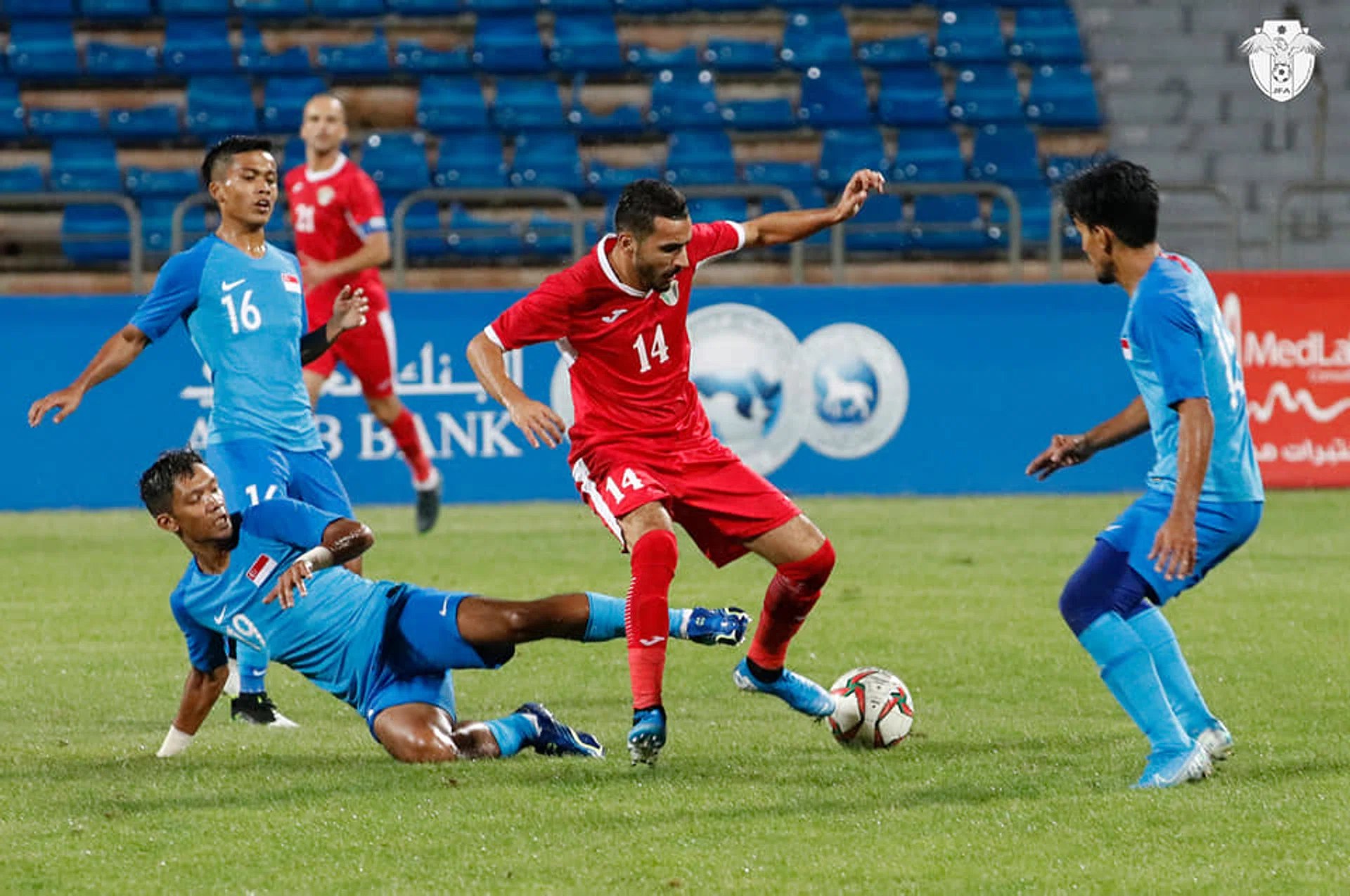 (From left, in blue) Singapore's Hami Syahin, Fareez Farhan and Yasir Hanapi keeping a close watch on a Jordanian opponent.