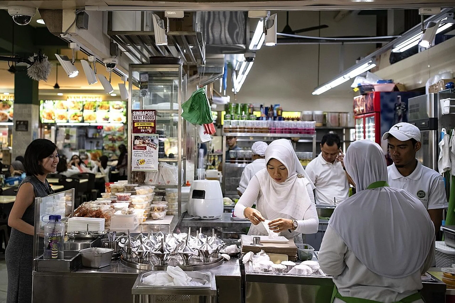 Ms Aisha working alongside her husband. 