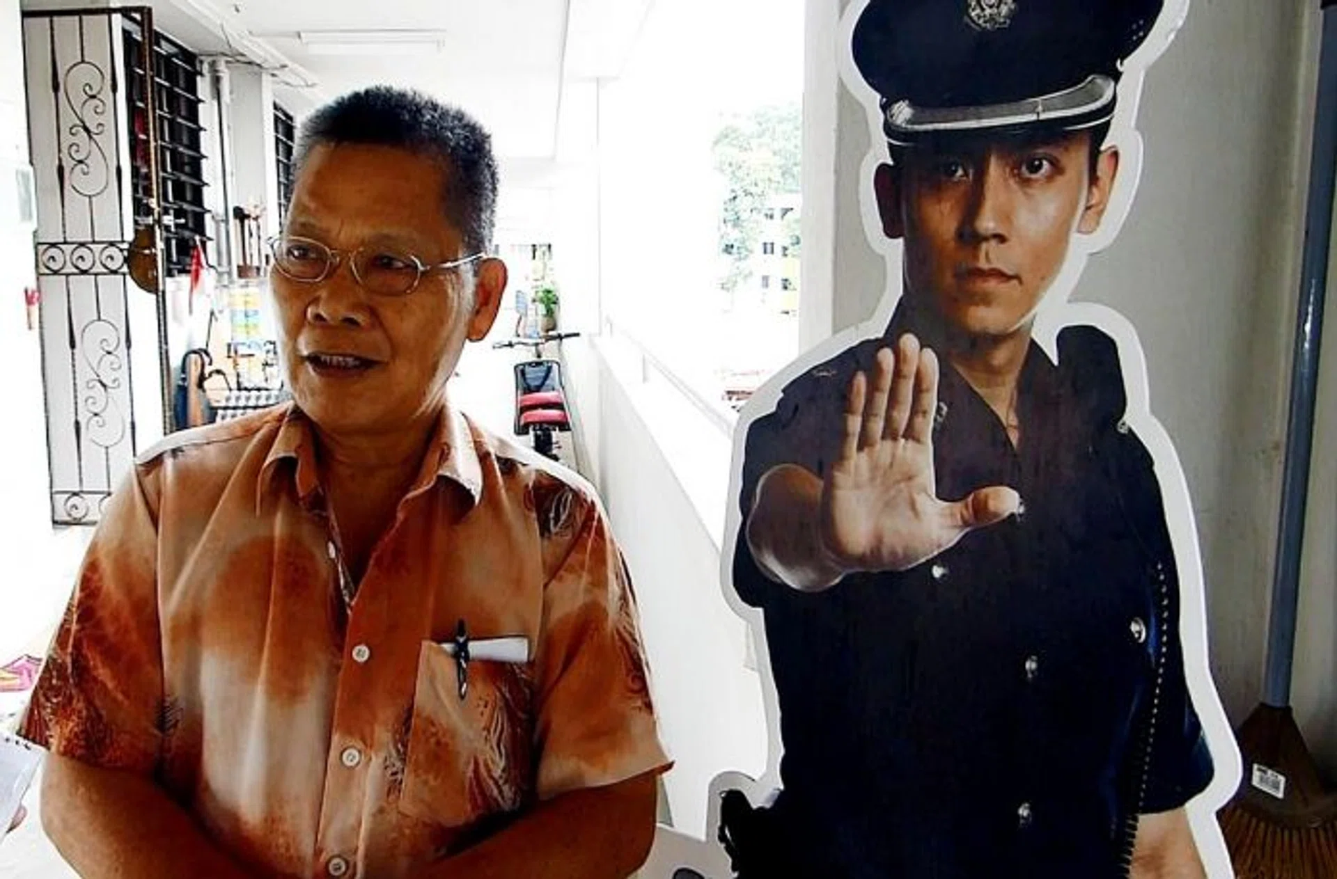 Mr Sim Ngiap Phua, 72, with the cardboard standee.