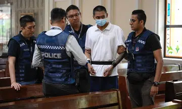 Police escort priest attack suspect at St Joseph's Church