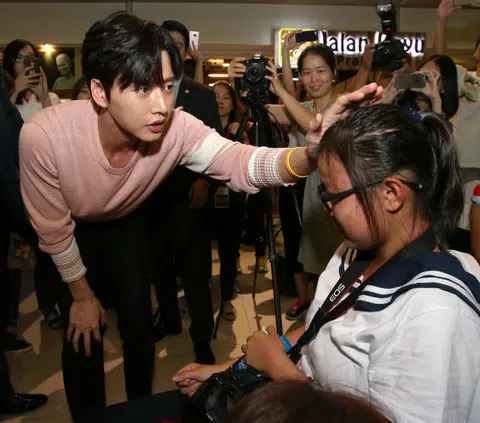 Crowd pushes, and she falls for him