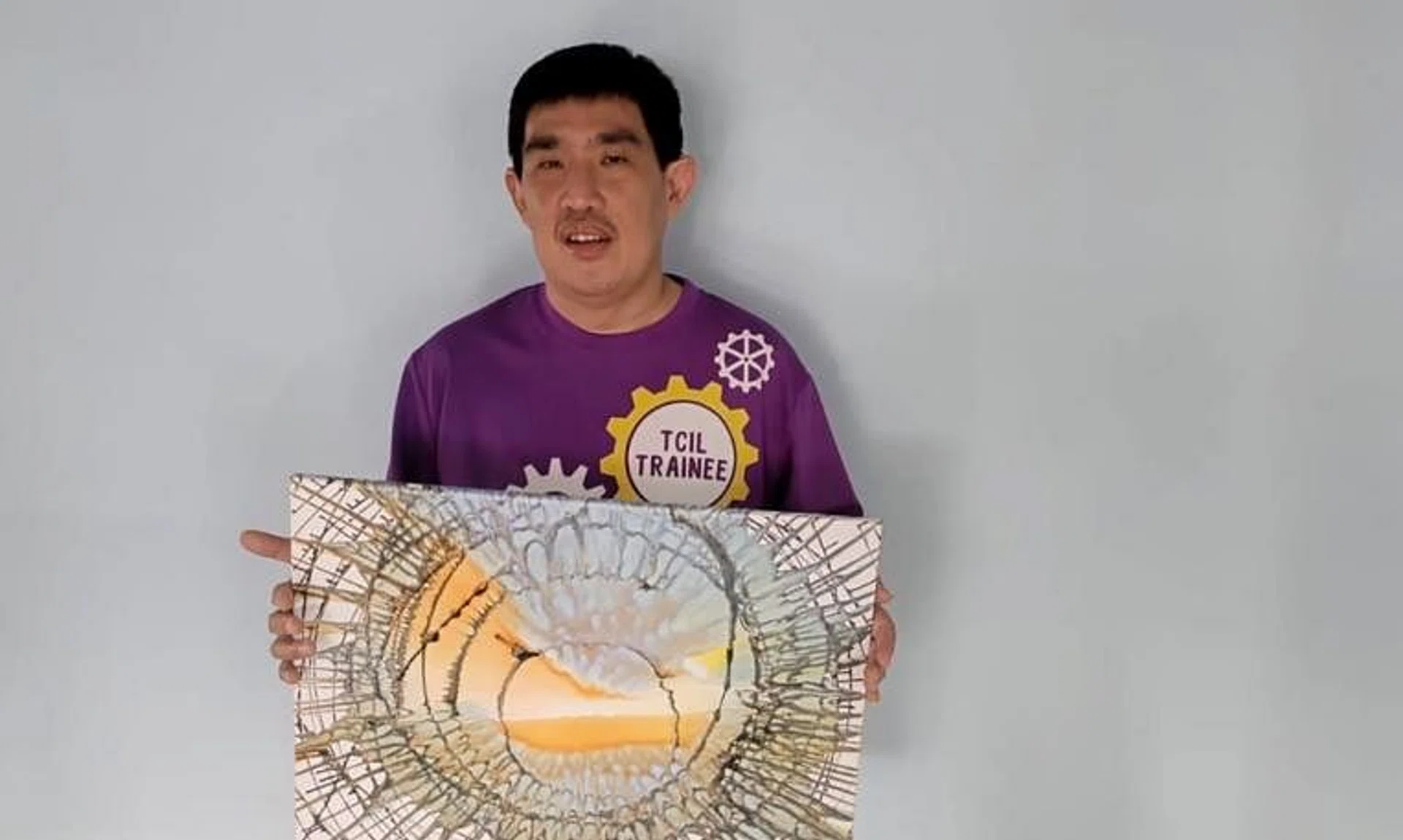 Mr Nigel Choo with an artwork he created at the Touch Centre for Independent Living.