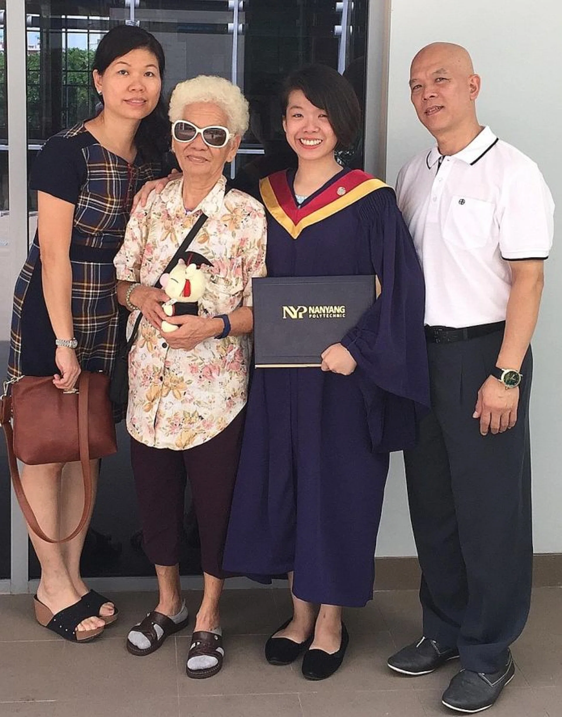 FAMILY SUPPORT: Ms Fanny Mong Li Yu (third from left) with her parents and grandmother at her graduation ceremony last week.