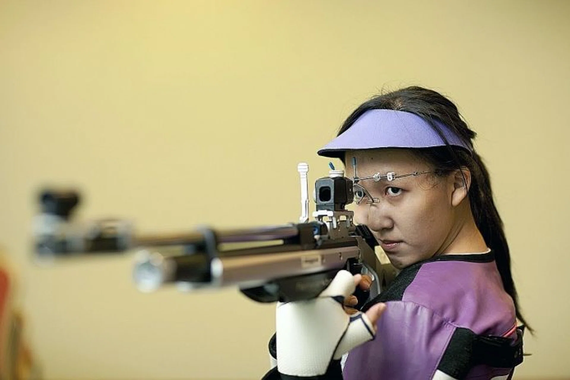 MIND OVER MATTER: Jasmine Ser (above) did not let a bout of food poisoning stop her from qualifying for the Olympics. Below, the 25-year-old with her gold medal from the Asia Olympic qualifying competition.