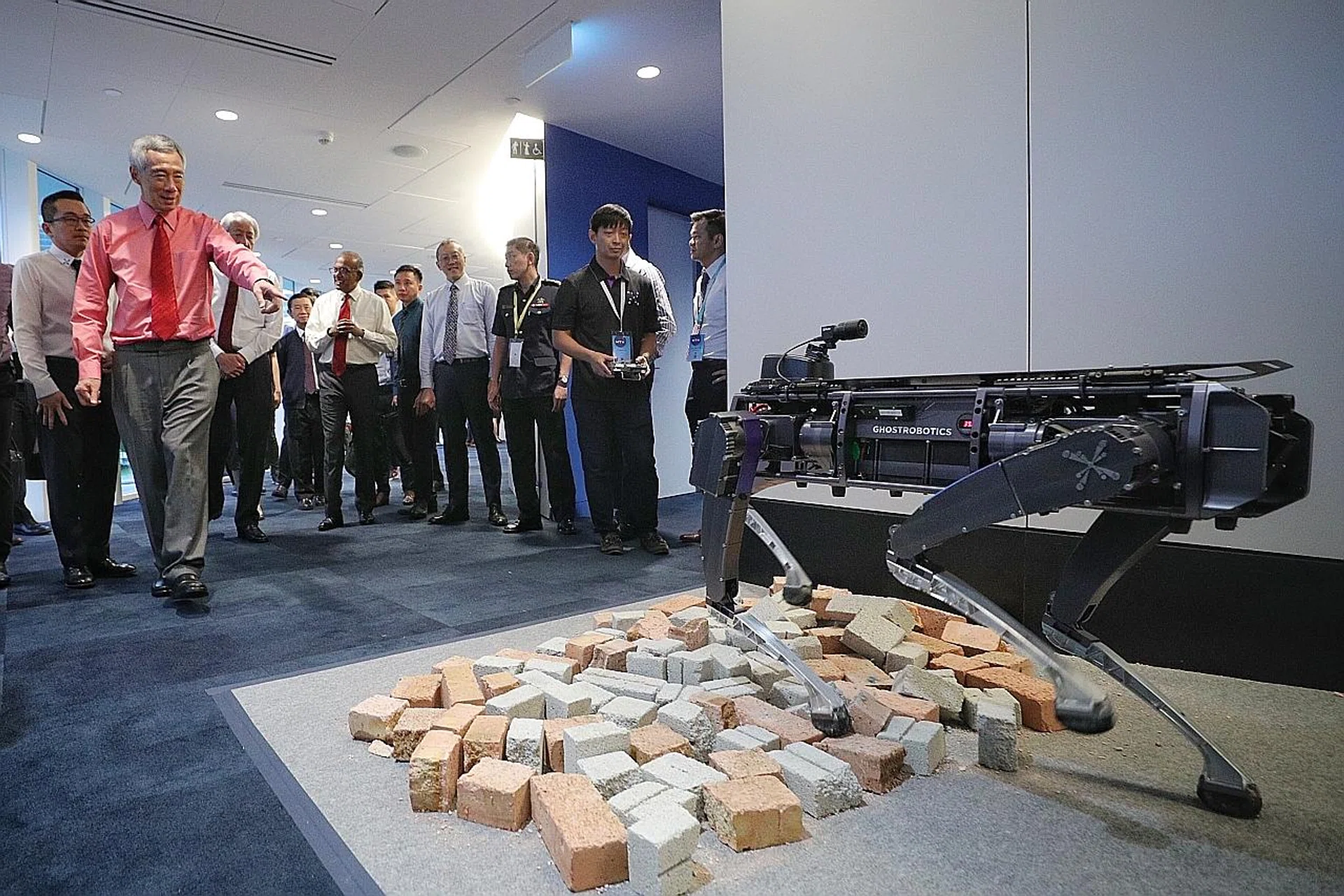 Prime Minister Lee Hsien Loong checks out a Rover-X robotic dog at the launch of the Home Team Science and Technology Agency. 