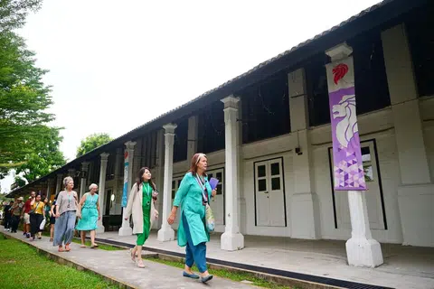 Jane's Singapore Tours founder Jane Iyer leading tour participants past an old army barrack at Dempsey Hill - then Tanglin Barracks - where much violence unfolded during the Singapore Mutiny in 1915.