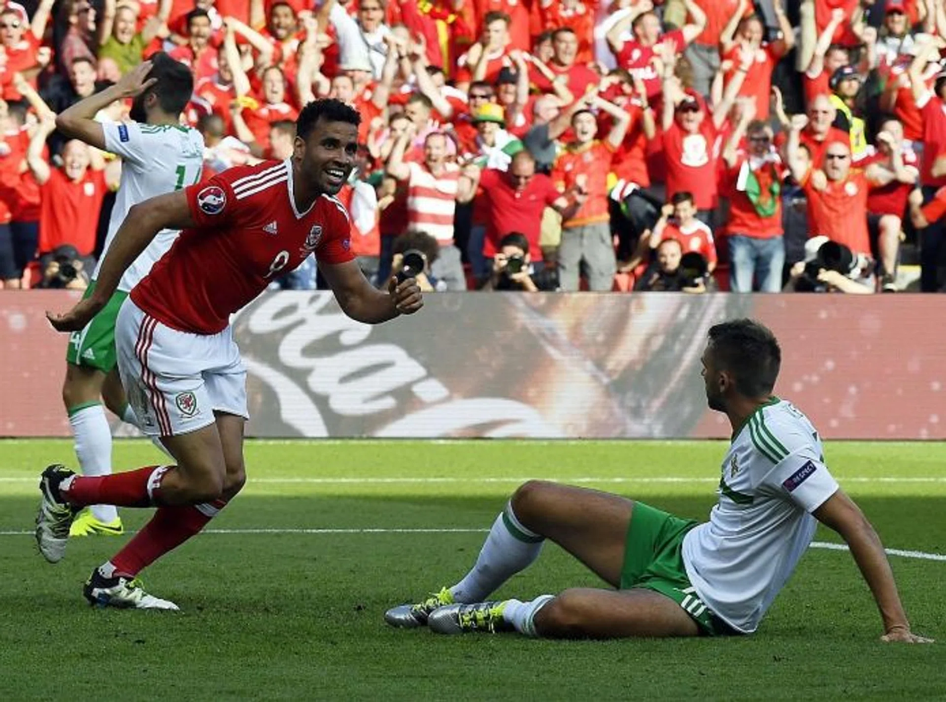 RELIEF: Wales forward Hal Robson-Kanu (left) celebrating after an own goal by Northern Ireland defender Gareth McAuley (on ground).