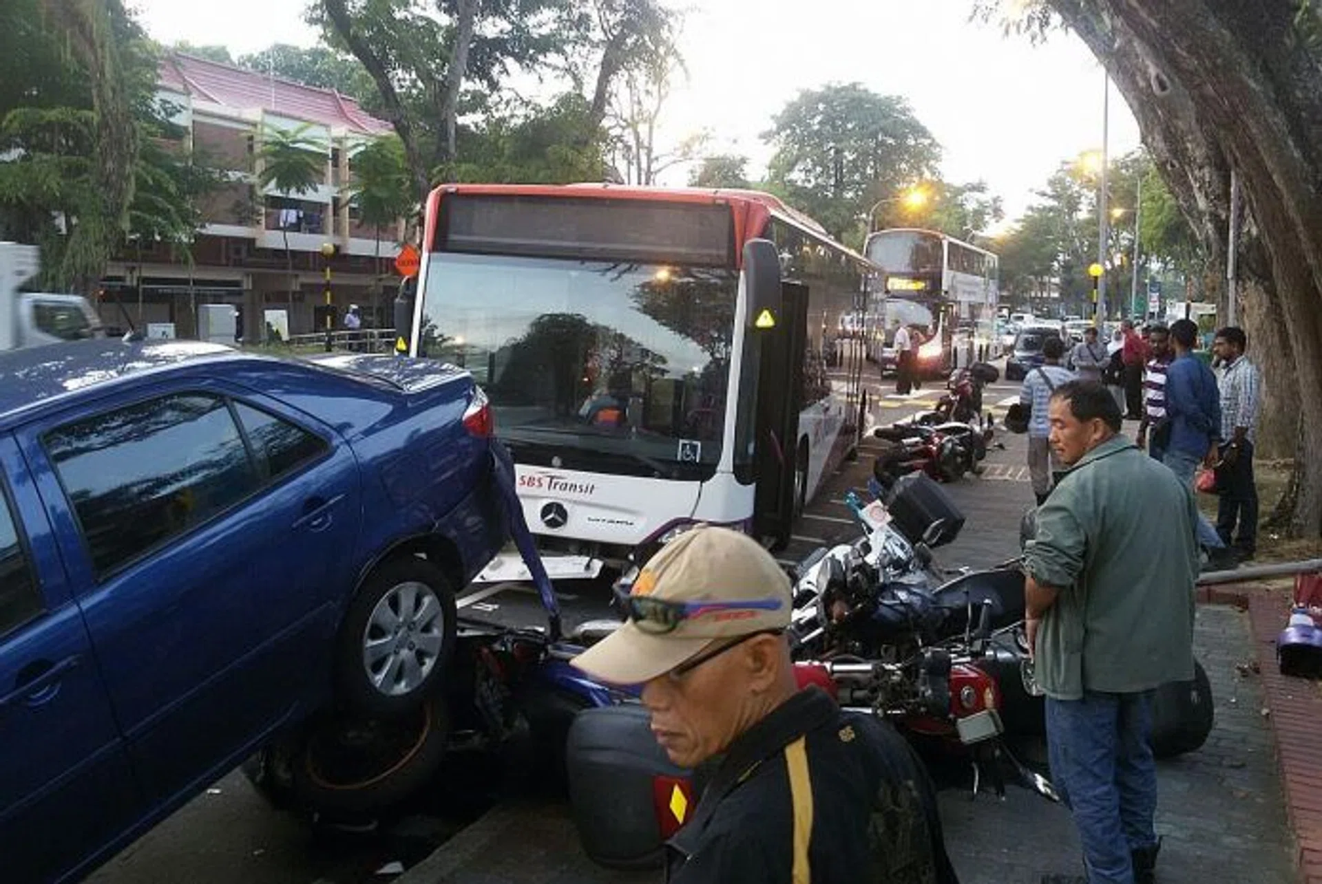 IMPACT: The impact of the accident pushed one of the motorcycles under a parked car. 