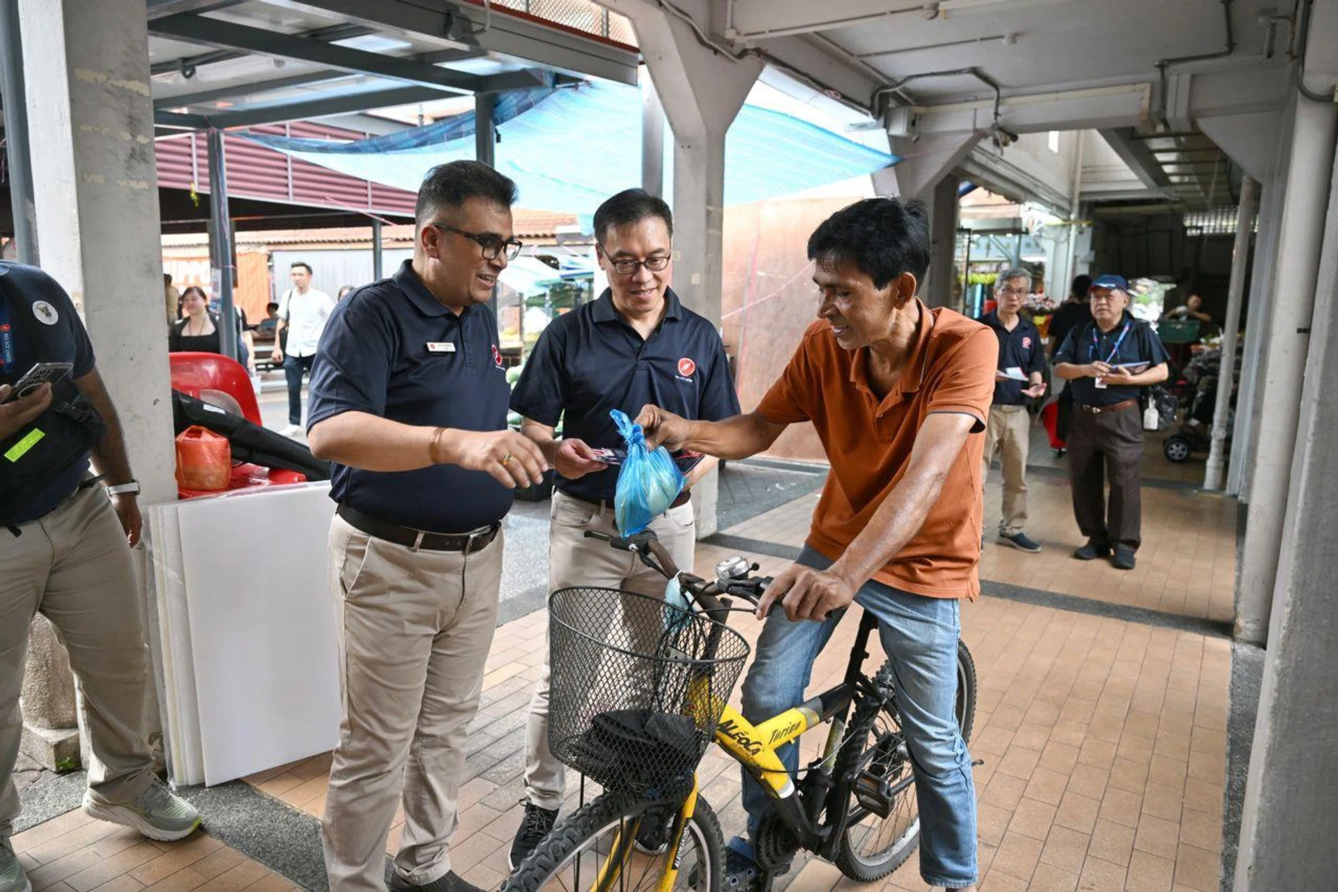 RDU secretary-general Ravi Philemon (left) and tech start-up business director Pang Heng Chuan, the party's new face, distributing porridge at Bukit Batok East Point on March 15.
