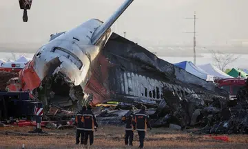 Why is there a concrete wall near the end of Muan Airport runway?